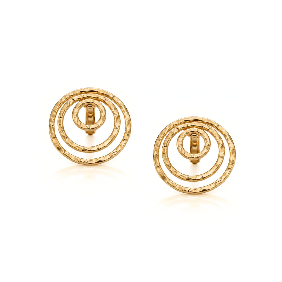 Hand-assembled in our West Hollywood studio, these clip-ons refract light across three rippled, concentric gold circles. Crafted in small batches from eco-conscious materials. Style Note: punctuates work shirts or slips effortlessly into evening.