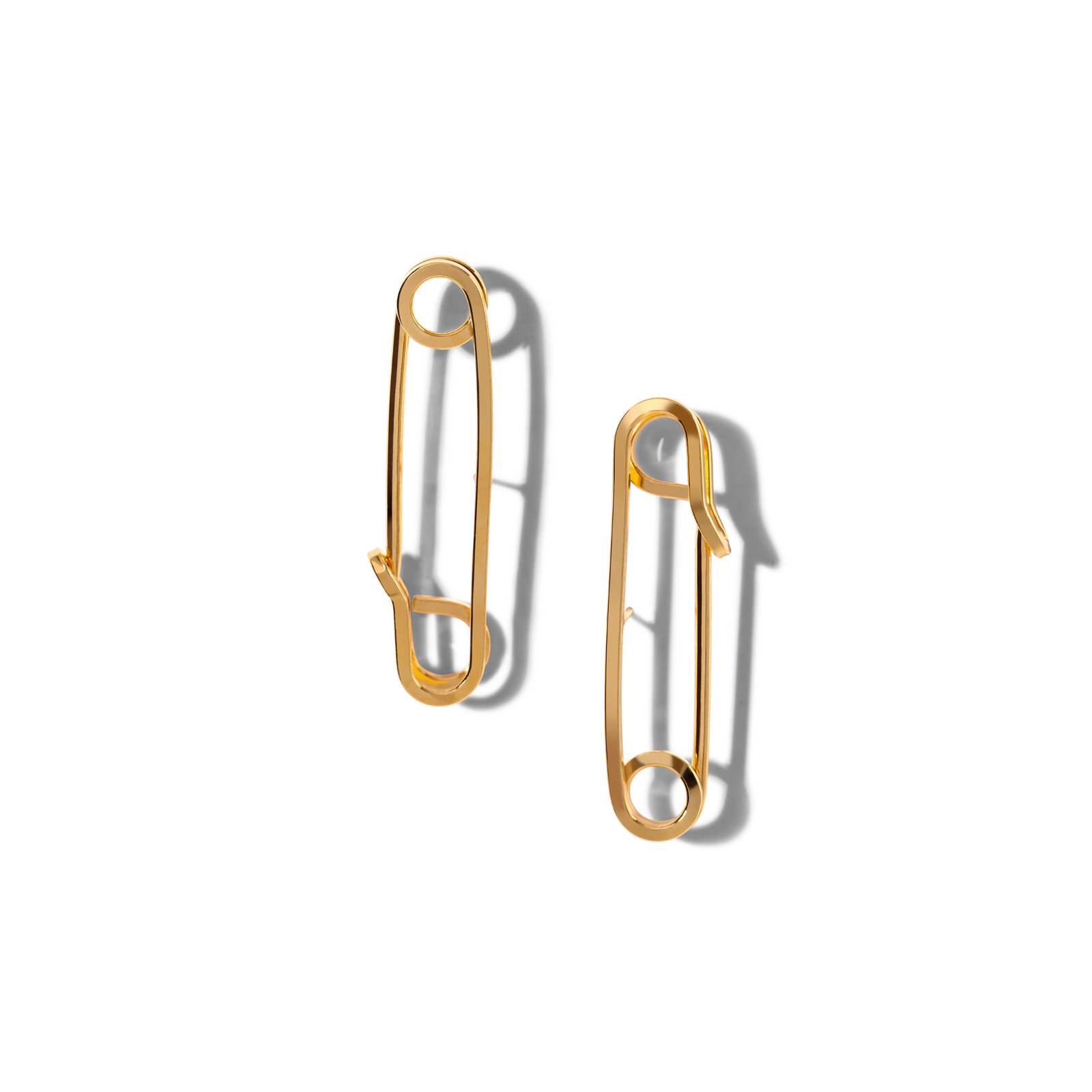 The Gold Safety First Post Earrings from JAREDJAMIN Jewelry Online are shown on a white background. Crafted with 18K Gold Plate, their bold safety-pin shape and smooth, minimalist finish stand out with a soft shadow.