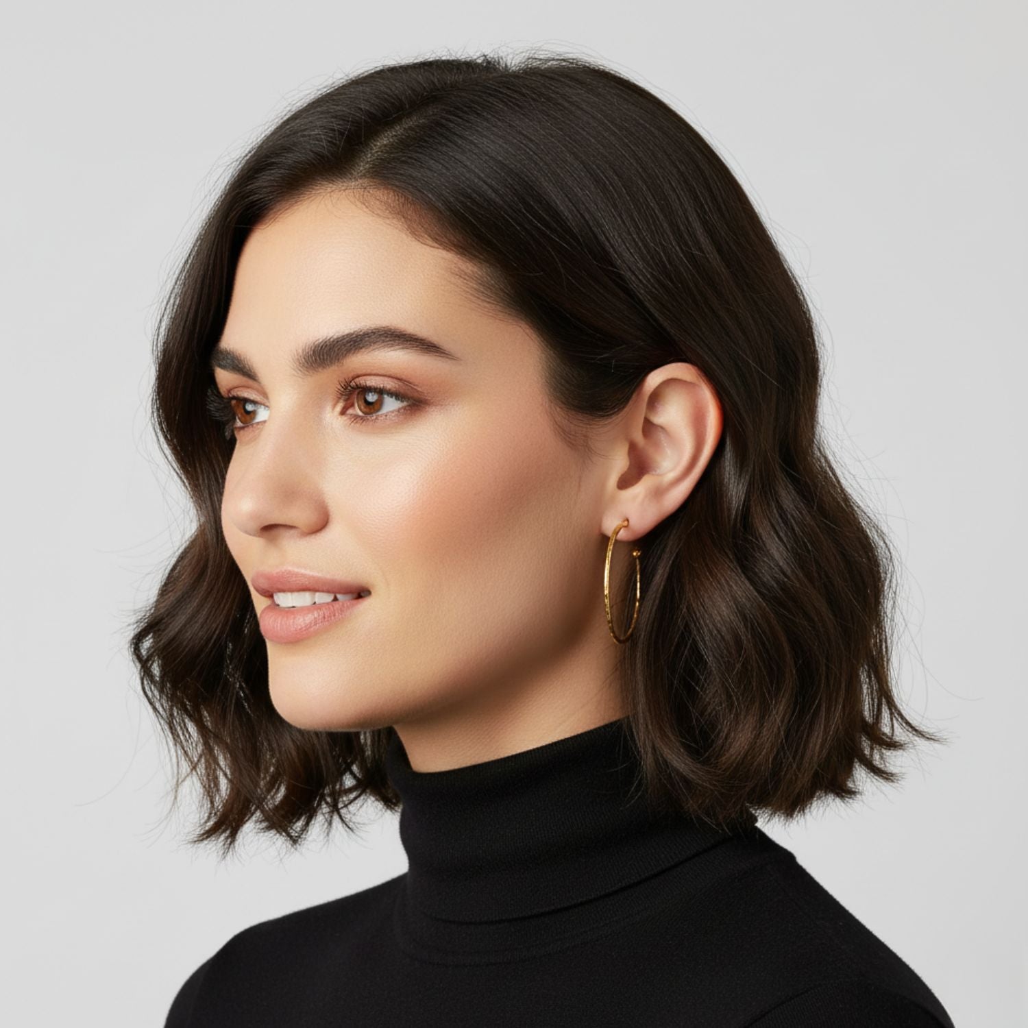 The Gold Small Hooptastic Hoop Post Earrings by JAREDJAMIN Jewelry Online feature a minimalist design with thin 18K gold plate hoops, each accented by a small sphere opposite the post, shown against a white background for an elegant look.