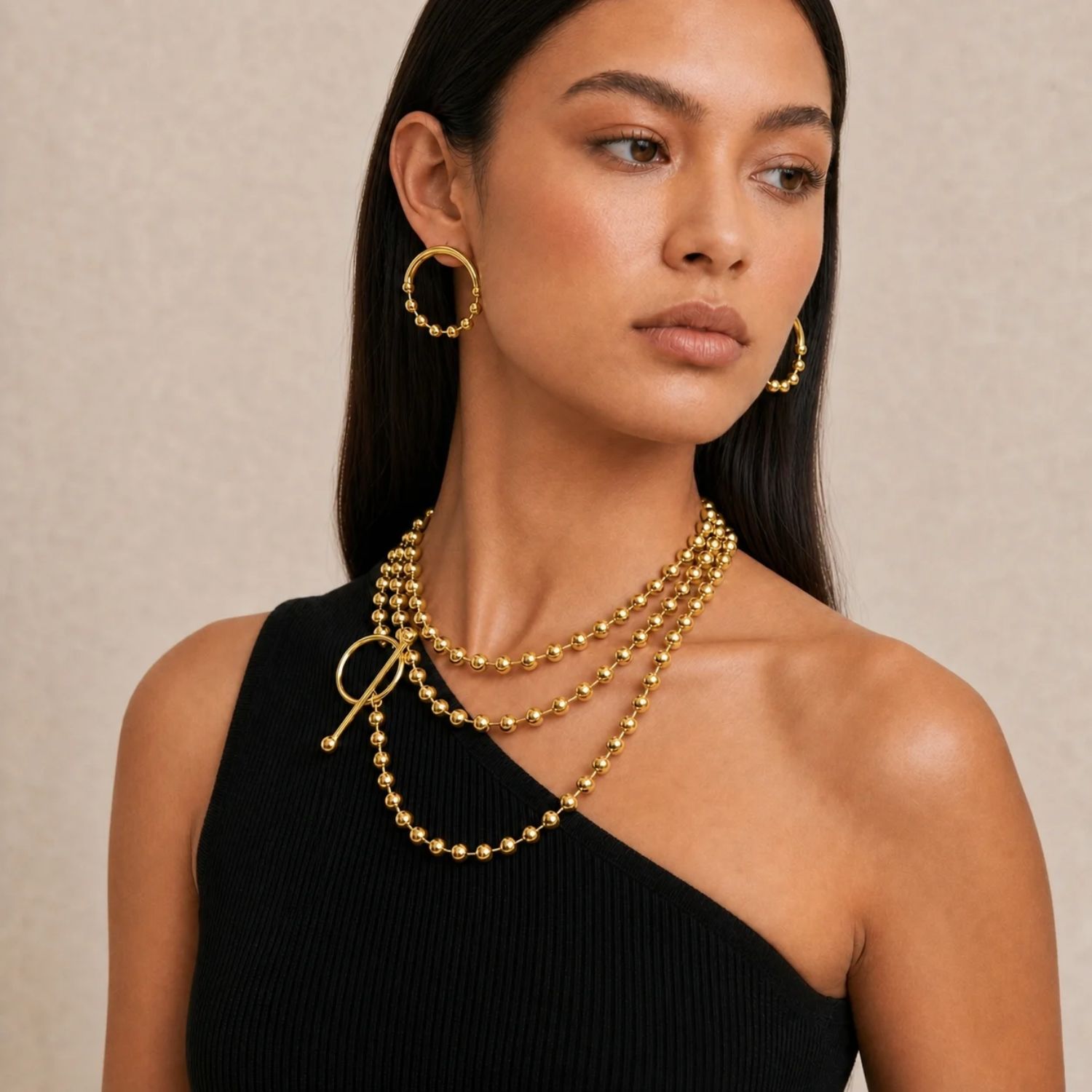The Gold Small Orbita Amari Post Earrings from JAREDJAMIN Jewelry Online feature smooth, rounded beads along each gold-plated hoop for a textured, elegant look. Displayed on a white background, they're crafted with 18K Gold Plate.