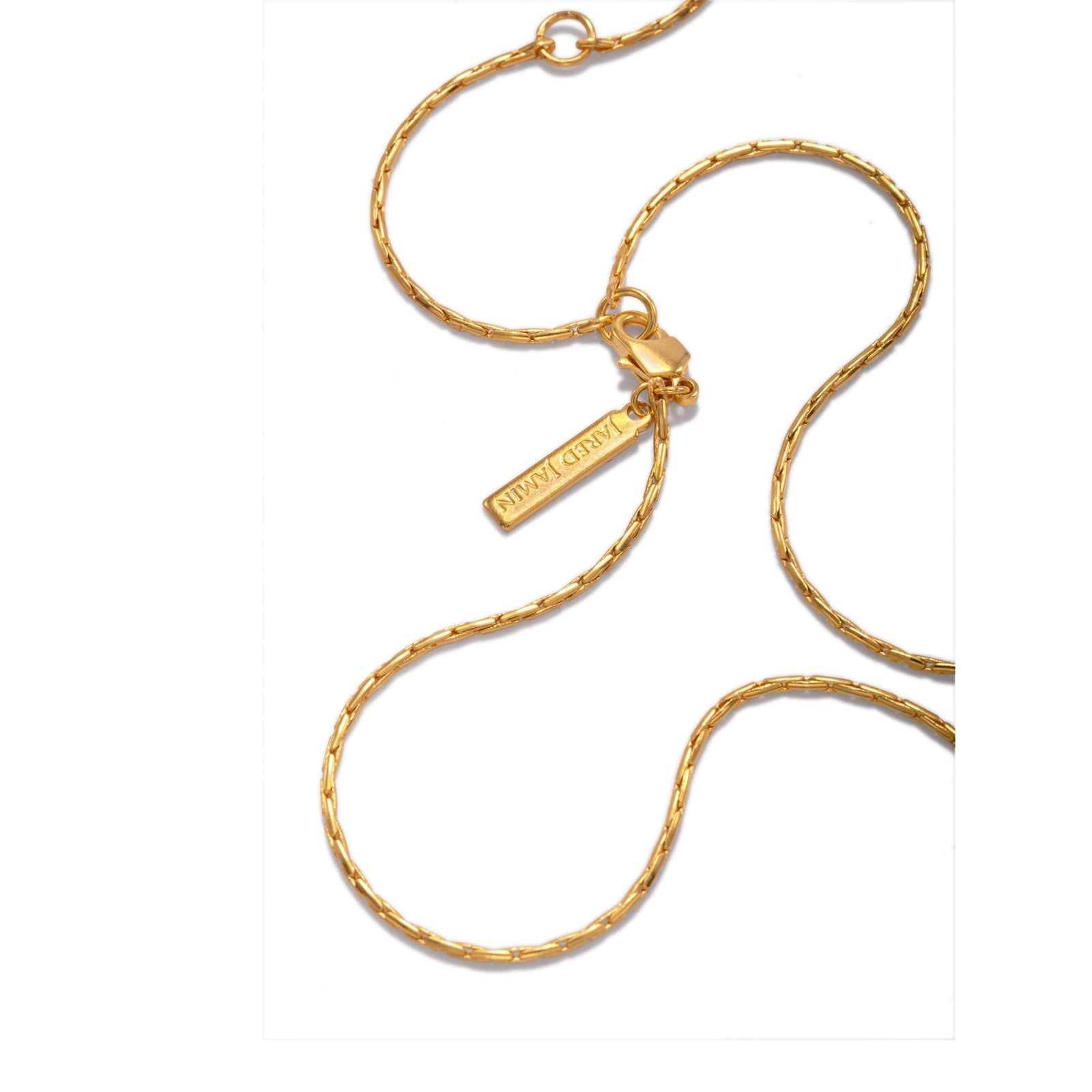 The Ricky Adjustable Chain Necklace by JAREDJAMIN Jewelry Online is shown on a white background. This unisex snake chain features a lobster clasp, extender with round charm, and a branded rectangular tag near the clasp.