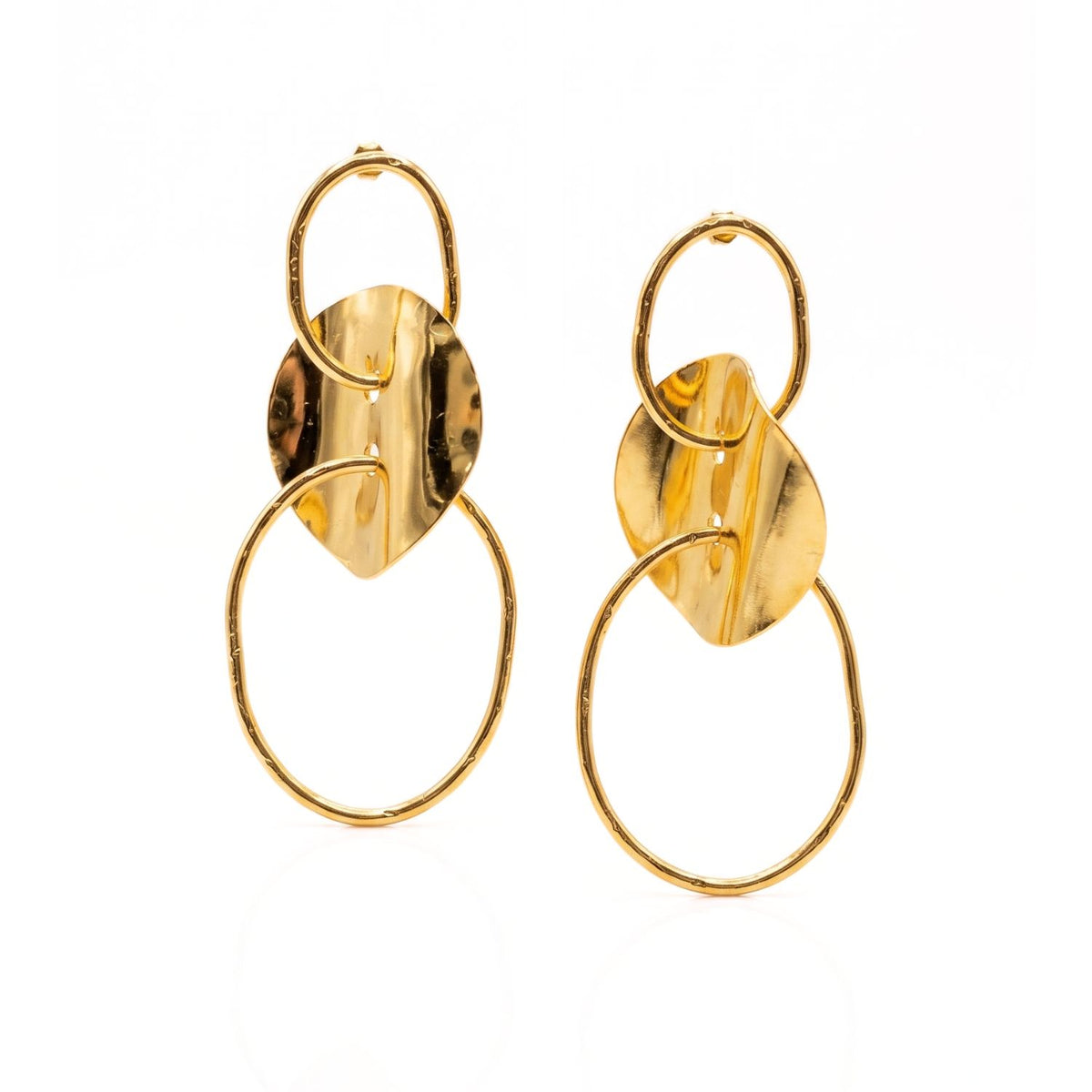 High-resolution studio product shot of the JAREDJAMIN Gold Viviane Post Drop Earrings, highlighting the three-tier architecture, hammered 18k gold-plated surfaces, and the undulating central wavy metal disc against a white background.