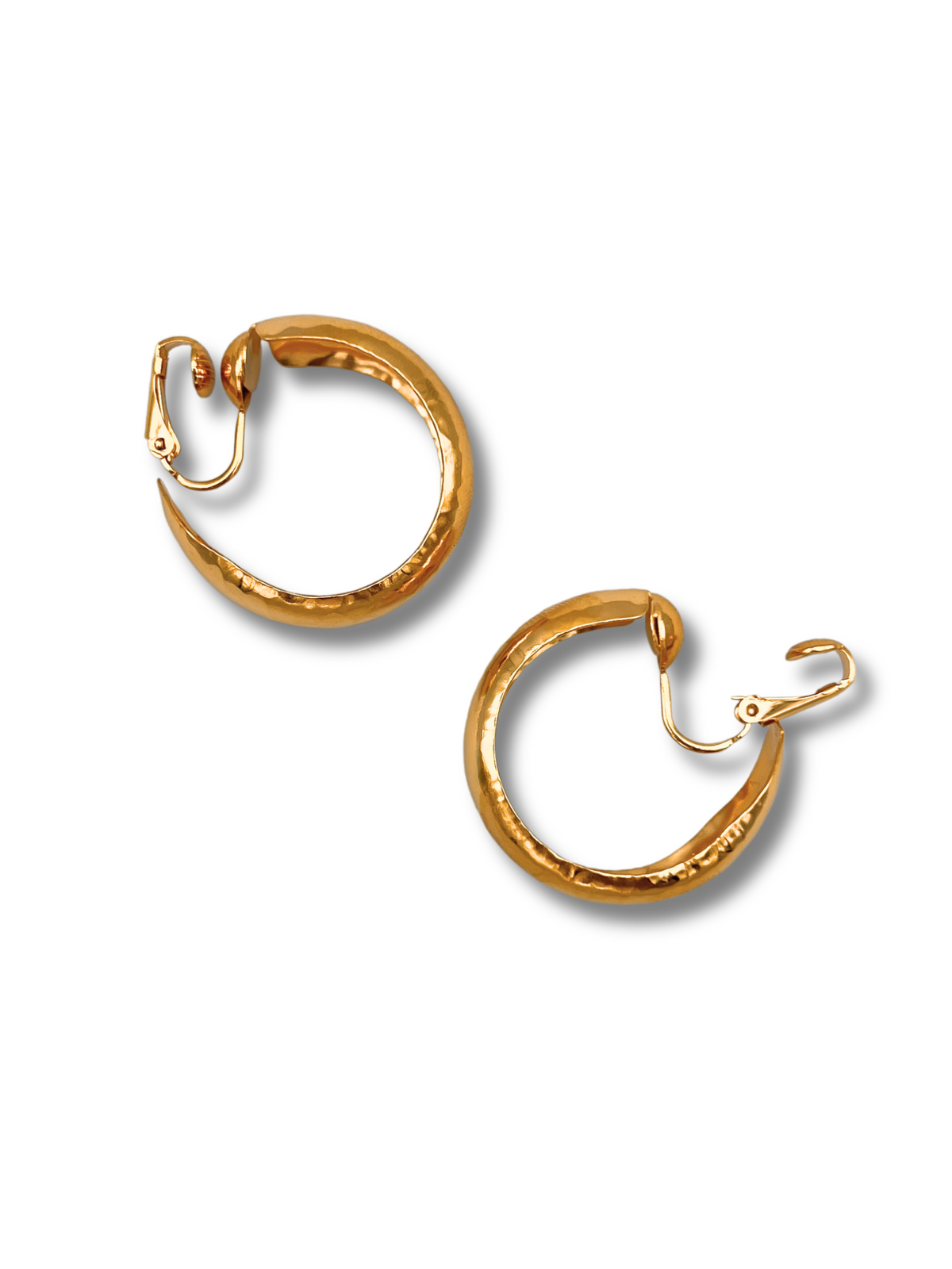 The Gold Rush Hoop Earrings by JAREDJAMIN Jewelry Online are displayed against a white background. Featuring 18K gold plating and latch back closures, their open design highlights a curved shape with a shiny hammered texture, adding dimension and elegance.