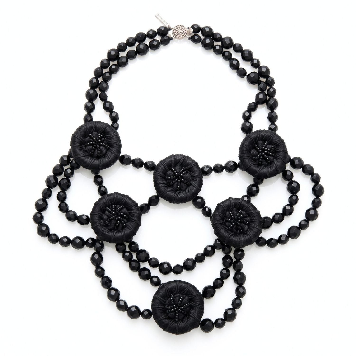 High-resolution, sharp e-commerce flat lay photography shot directly from above using a Canon EOS 5D Mark IV with a macro lens, featuring the JAREDJAMIN Good Mourning Victoria Necklace on a crisp white background to highlight the black faceted glass beads and satin-wrapped vintage buttons.