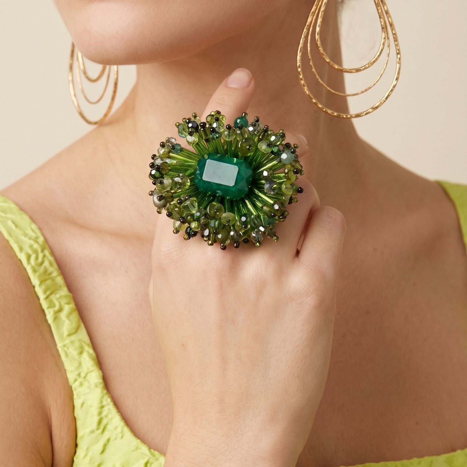 High-resolution, sharp e-commerce flat lay photography shot directly from above using a Canon EOS 5D Mark IV with a macro lens, featuring the JAREDJAMIN Ivy Green Beaded Burst Ring on a white background to highlight the dyed green quartz center and hand-embroidered glass bead halo.