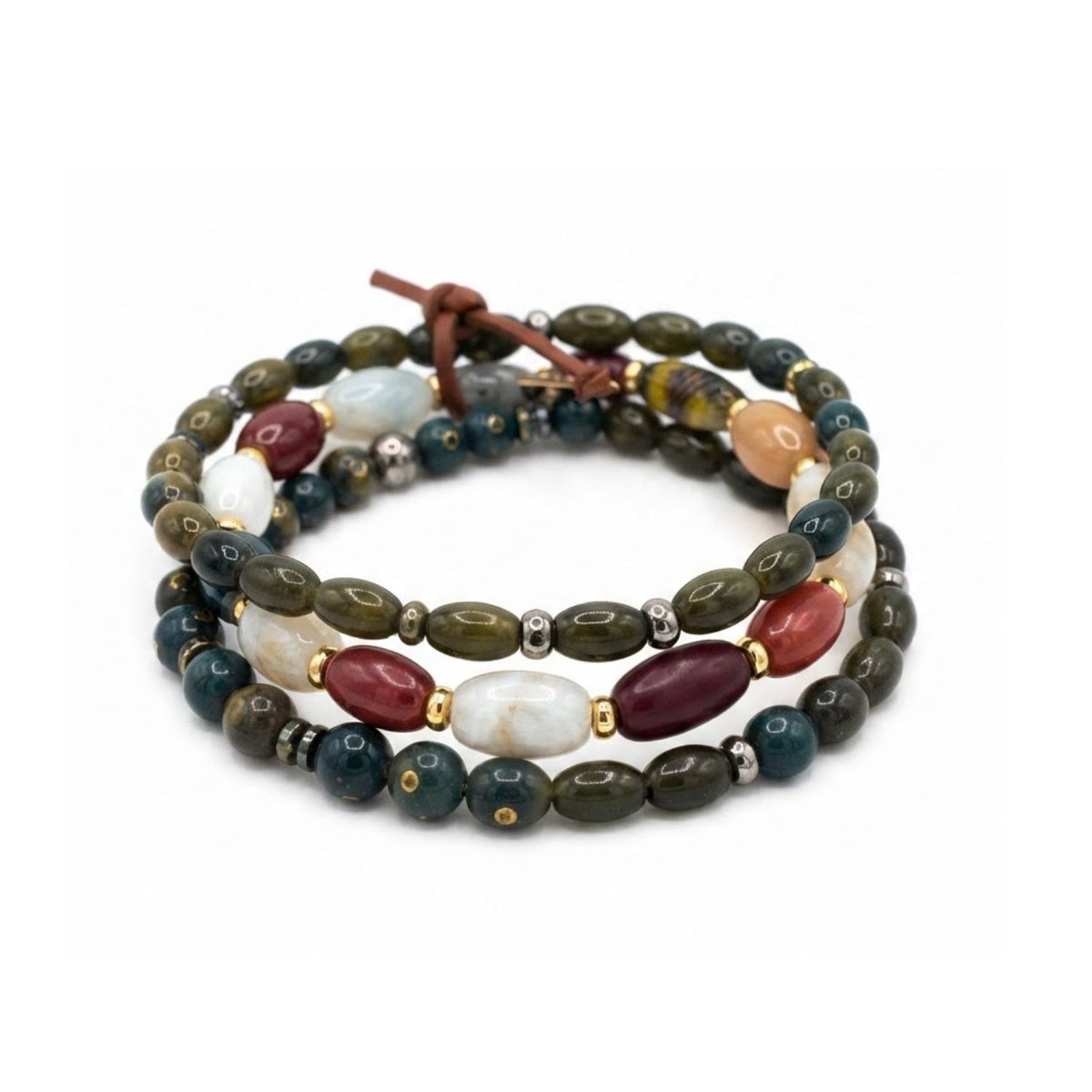 High-resolution studio product shot of the JAREDJAMIN Silvan Men's 3-Piece Stackable Bracelet Set displayed flat against a white backdrop, highlighting the green oblong wood, round jasper, oval football-shaped quartz beads, and signature brown leather tie.