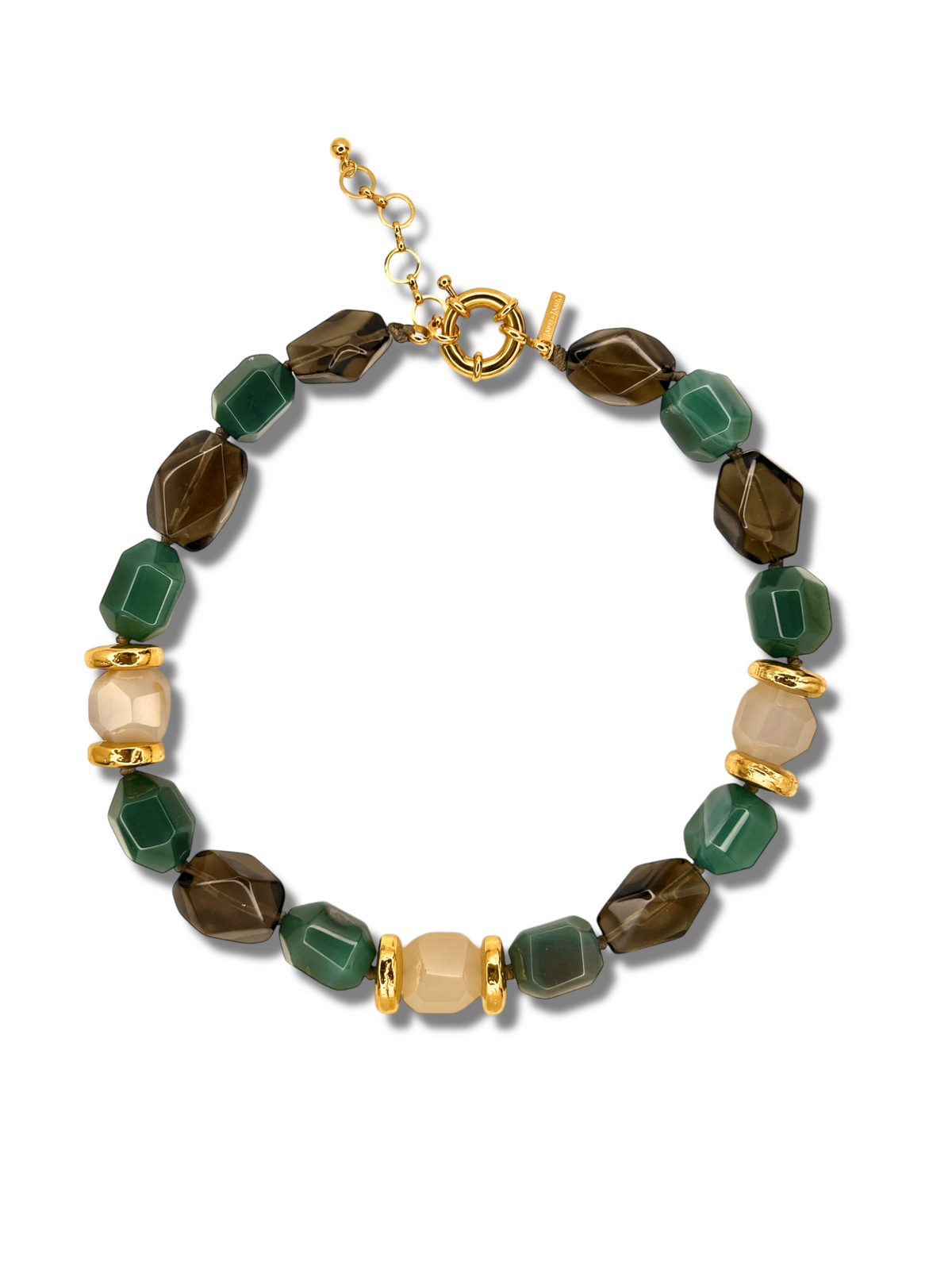 The Green Dream Necklace by JAREDJAMIN Jewelry Online features faceted green agate and stones in brown and beige tones, complemented by gold-tone spacer beads. It includes a gold-tone clasp with an adjustable chain, beautifully arranged in a circle on a white background.