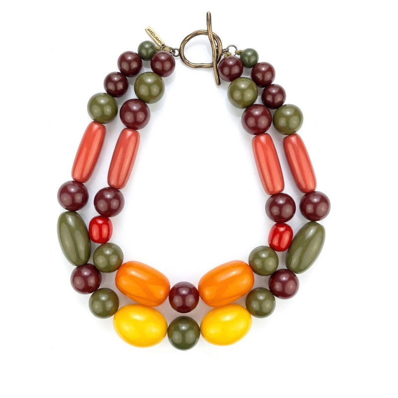 JAREDJAMIN’s Tallulah Statement Collar showcases chunky olive green, burgundy, red, orange, and yellow beads with a bold round toggle clasp. Crafted in small batches West Hollywood, it highlights artisanal skill, sustainable luxury, and signature brushed textures.