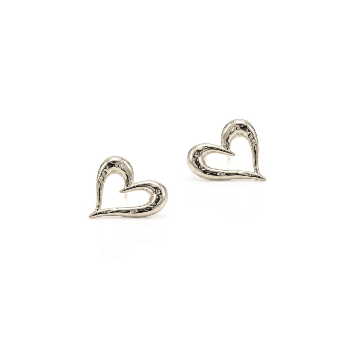 Hand-assembled in our West Hollywood studio, these sculpted heart earrings punctuate negative space with an open-core silhouette. Small-batch and eco-conscious. Style Note: refracts charm from a tailored blazer to silk slip dress with ease.