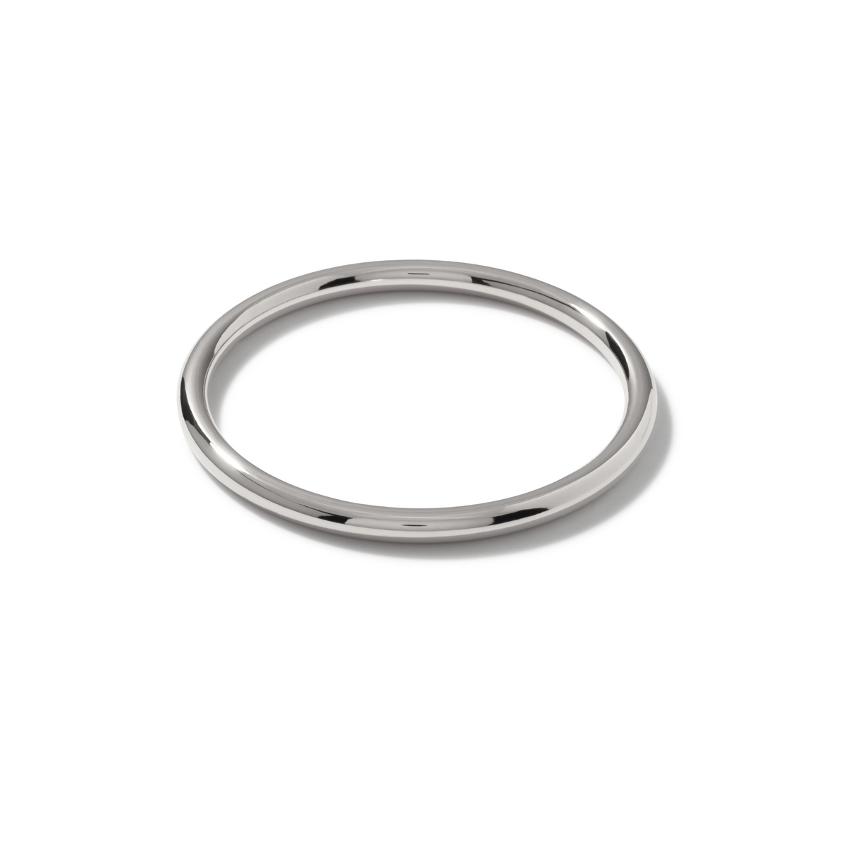 The JAREDJAMIN Jewelry Online Heavenly Hoop Bangle Pendant features a polished silver, round bangle with a delicate circle charm, shown on a white background and casting a soft shadow to highlight its sleek, minimalist design.