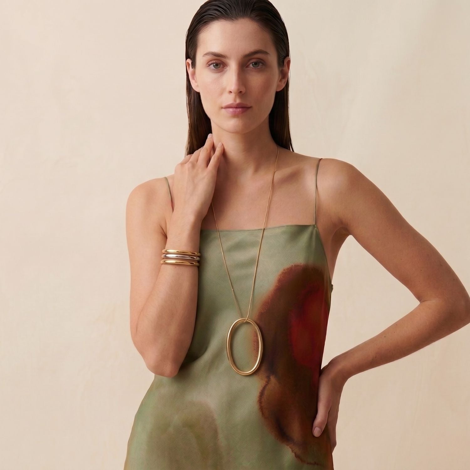 The Heavenly Hoop Oval Pendant Necklace by JAREDJAMIN Jewelry Online features a minimalist 18K gold-tone snake link chain with a large, smooth oval solid brass pendant, showcased on a plain white background with the clasp visible at the top.