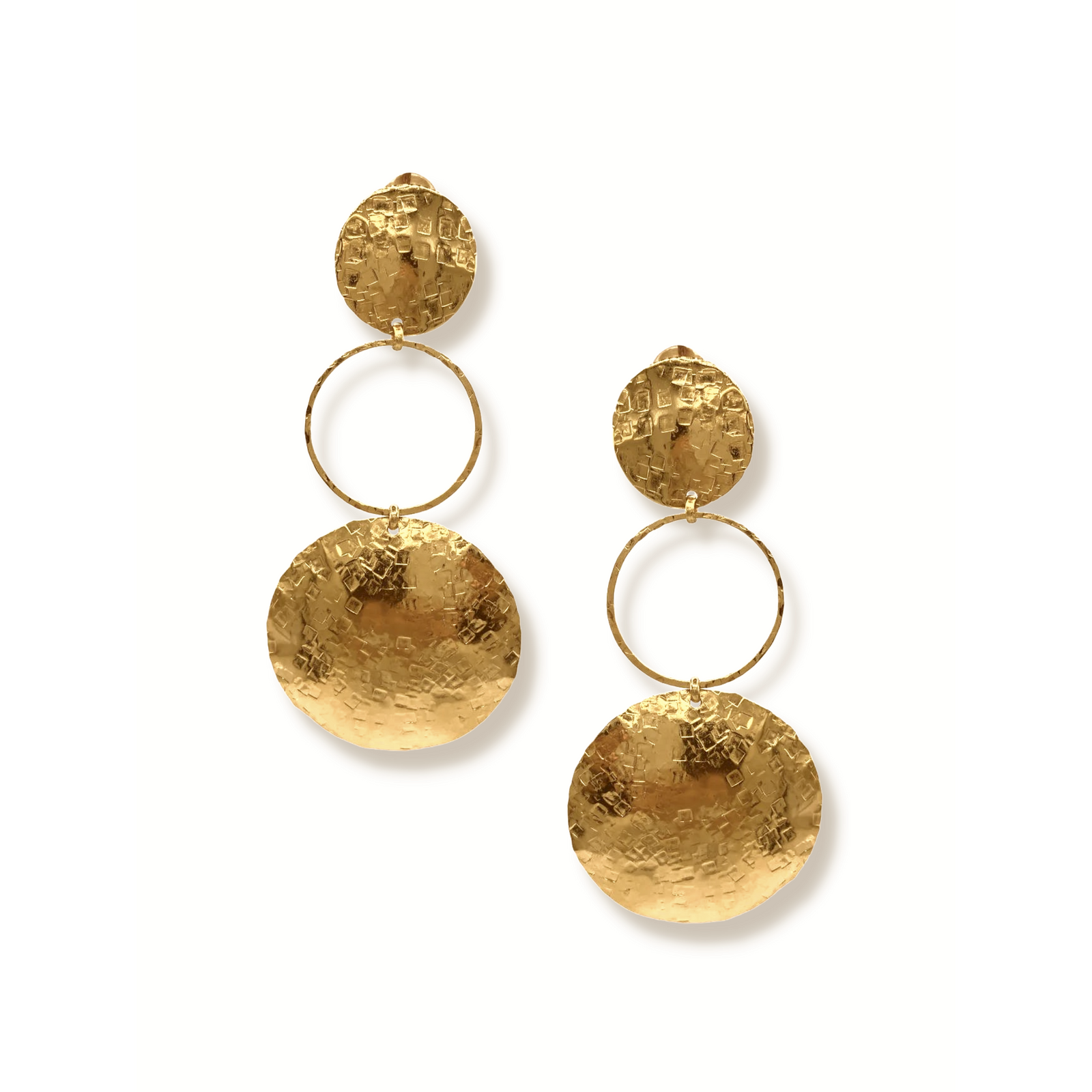 The Hera Textured Clip On Earrings by JAREDJAMIN Jewelry Online feature 18K gold plating, a small textured disc, a thin hoop center, and a larger hammered disc below for a luxe, reflective finish.