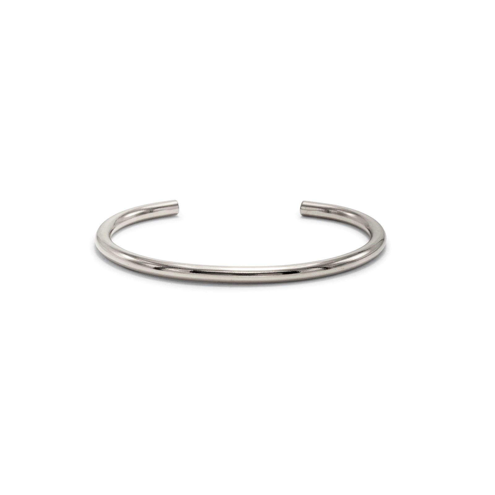 The Silver Tubular Cuff from JAREDJAMIN Jewelry Online features a sleek, polished silver finish and smooth round shape. Its open-ended C design ensures easy wear and stacking, while a plain white background showcases its minimalist style.