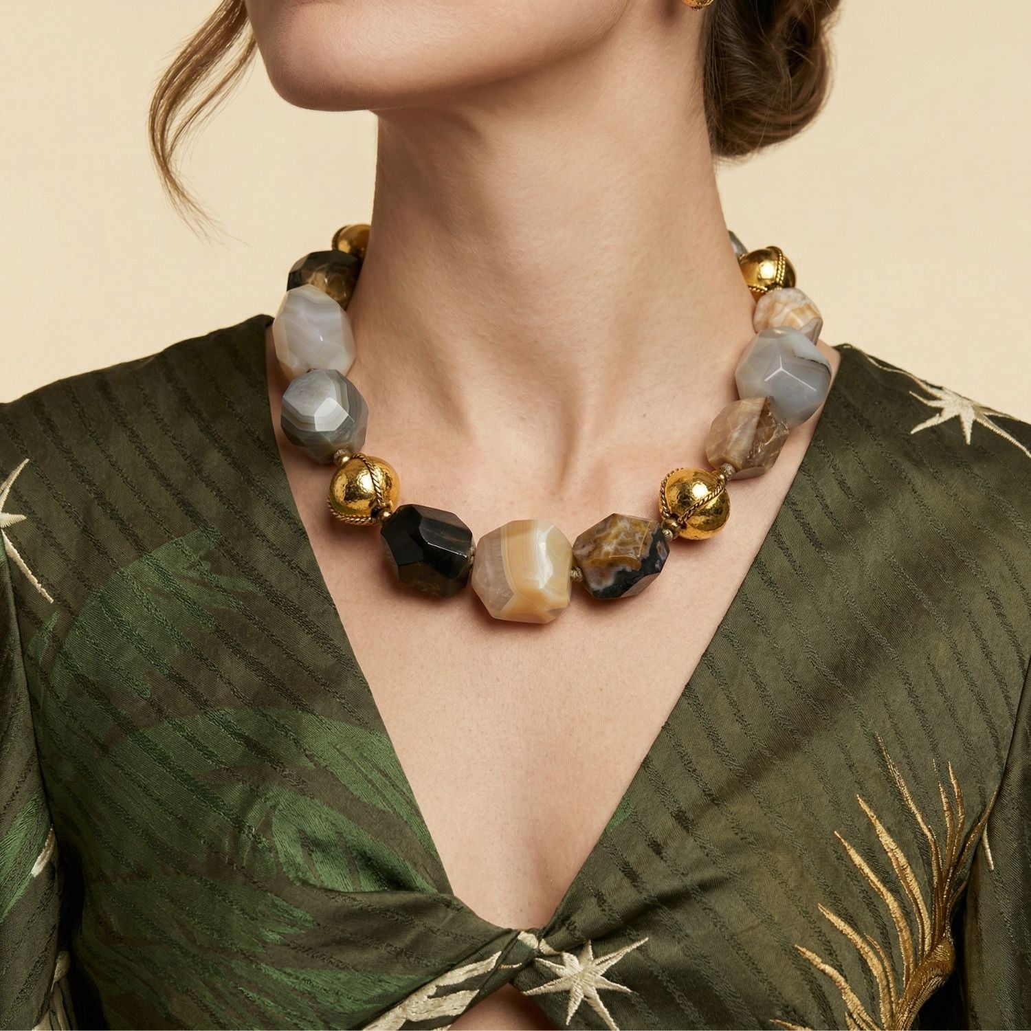 JAREDJAMIN Isolde Agate Necklace: A full view of the hand-knotted necklace featuring chunky, asymmetrical faceted agate pebbles in earthy grey, brown, and black tones with 18k gold-plated brass accents.