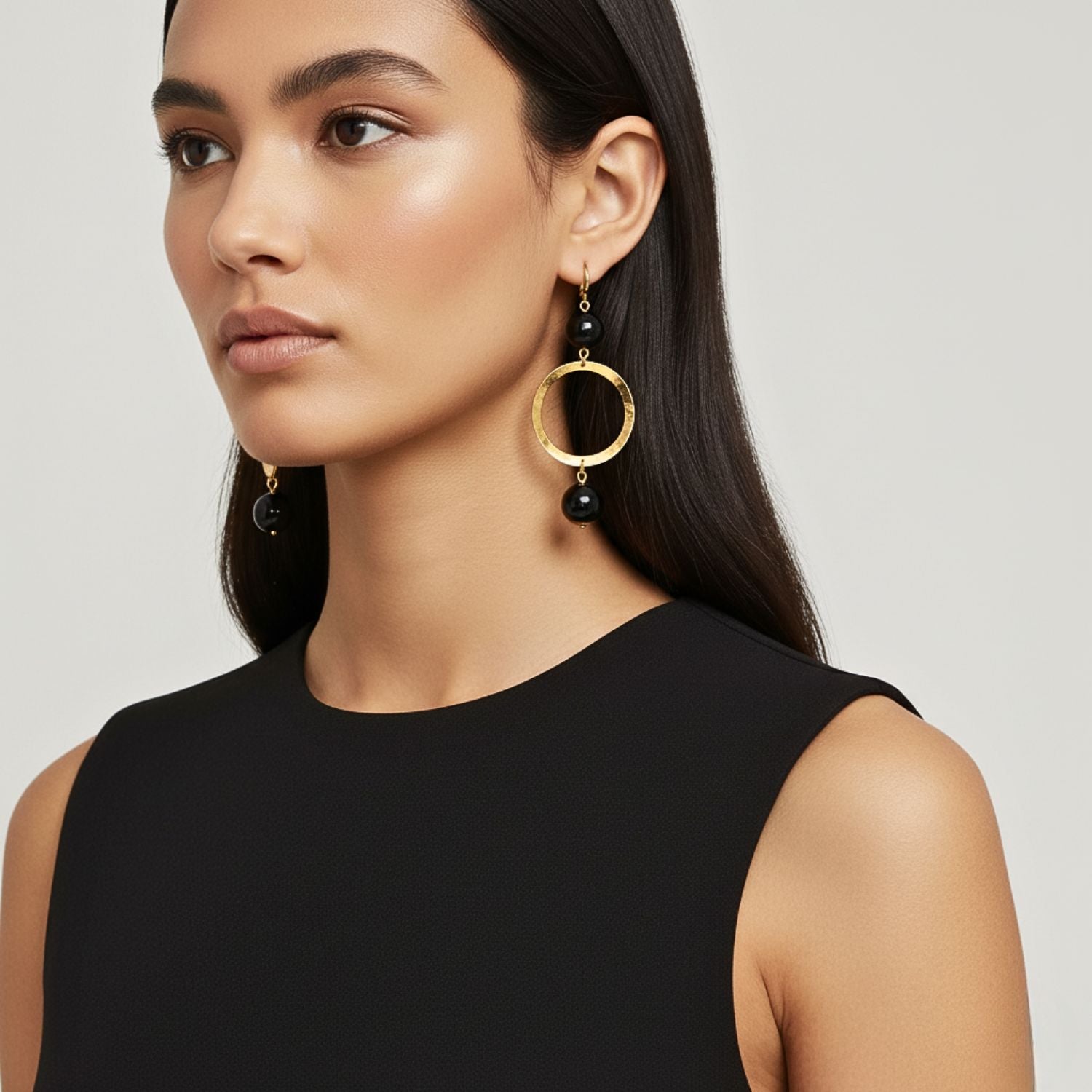 The Ursula Gold Onyx Earrings by JAREDJAMIN Jewelry Online feature 18K gold hammered hoops with glossy black beads, gold hooks, and a modern, hypoallergenic design—perfect for sensitive ears.