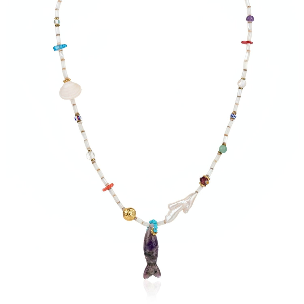 Studio product layflat shot of the Marisol necklace against a white background, highlighting the purple carved Amethyst gemstone fish pendant option suspended from the mother-of-pearl strand, flanked by a coral branch-shaped pearl and gold hematite spacers.