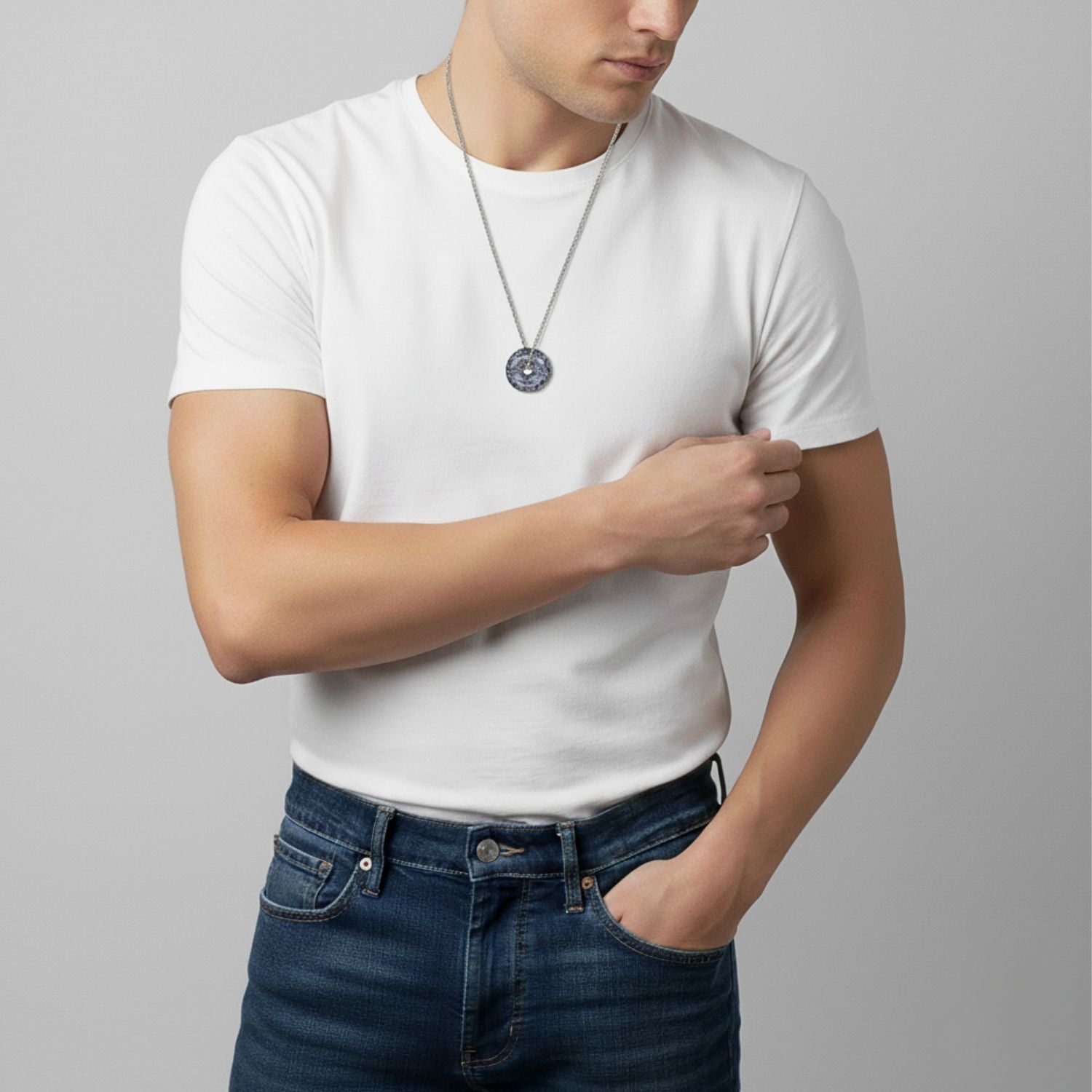 The Ash and Or Sterling Silver Necklace from JAREDJAMIN Jewelry Online showcases elongated links, a round gray-black marbled jasper pendant with a central hole, and an adjustable unclasped design with a slender bar fastening.