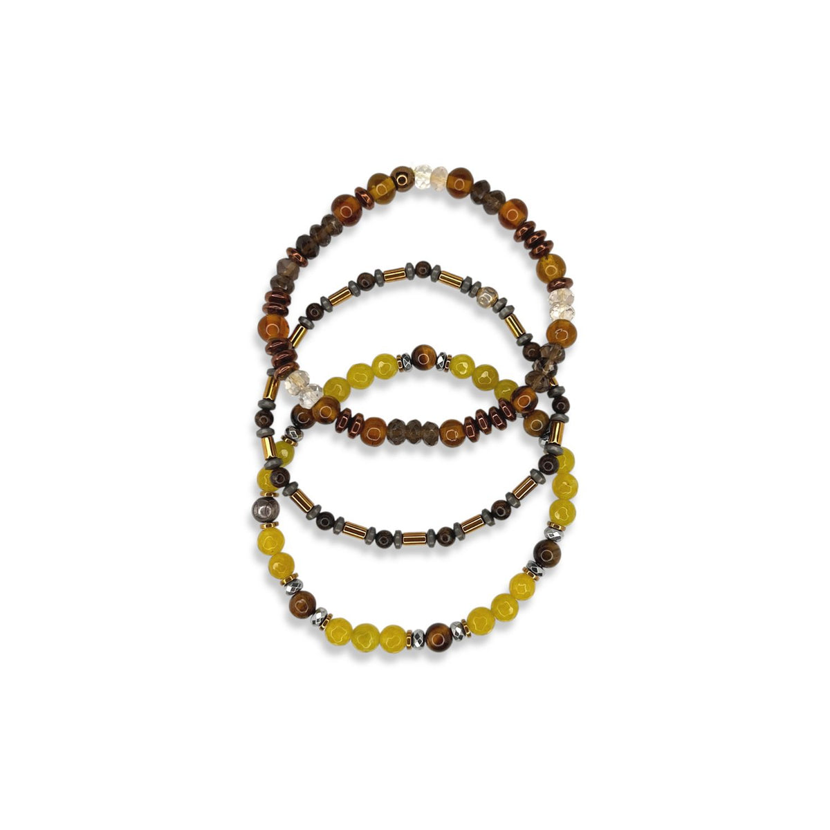 The Canyon Country Bracelet Set by JAREDJAMIN Jewelry Online features three stretch bracelets with round and cylindrical beads in brown, amber, yellow, metallic tones, and hematite accents, arranged in overlapping circles on a white background.