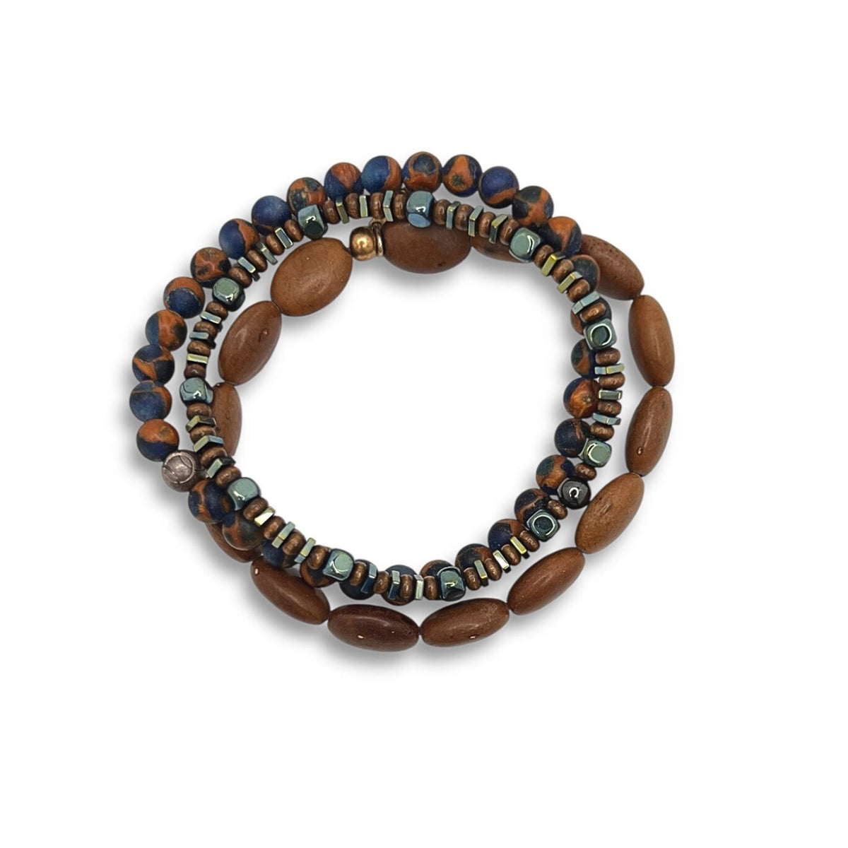The Coffee King Bracelet Set by JAREDJAMIN Jewelry Online features coiled rows of dark blue and brown round beads, greenish square beads, freshwater pearls, and large oval brown wooden beads for a stacked, textured shine.