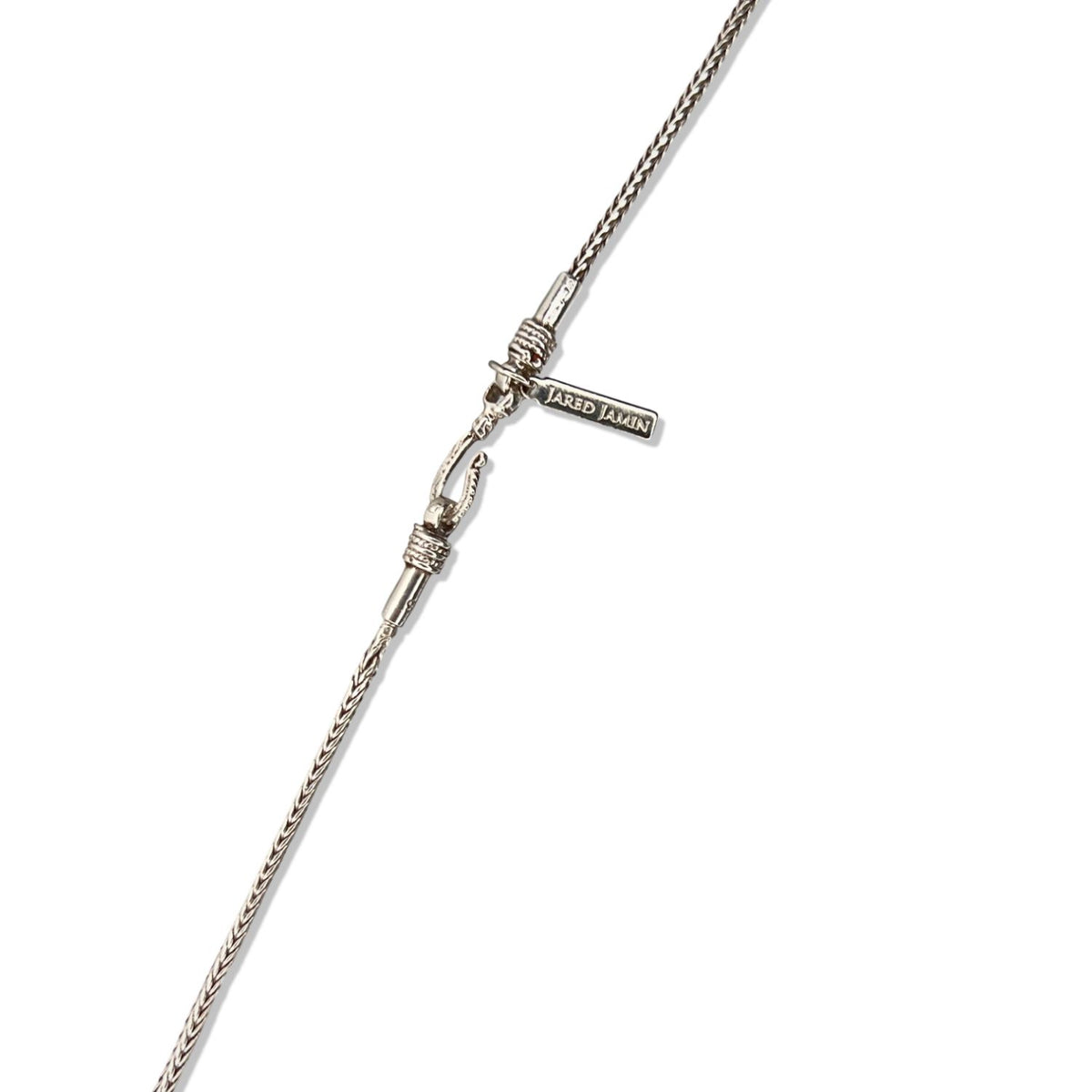 A close-up of the Confidence Boost Necklace by JAREDJAMIN Jewelry Online shows a sterling silver chain with a detailed clasp shaped like a hand holding a stick, and a tag engraved &quot;JARED JAMIN&quot; against a plain white background—perfect for boosting confidence.