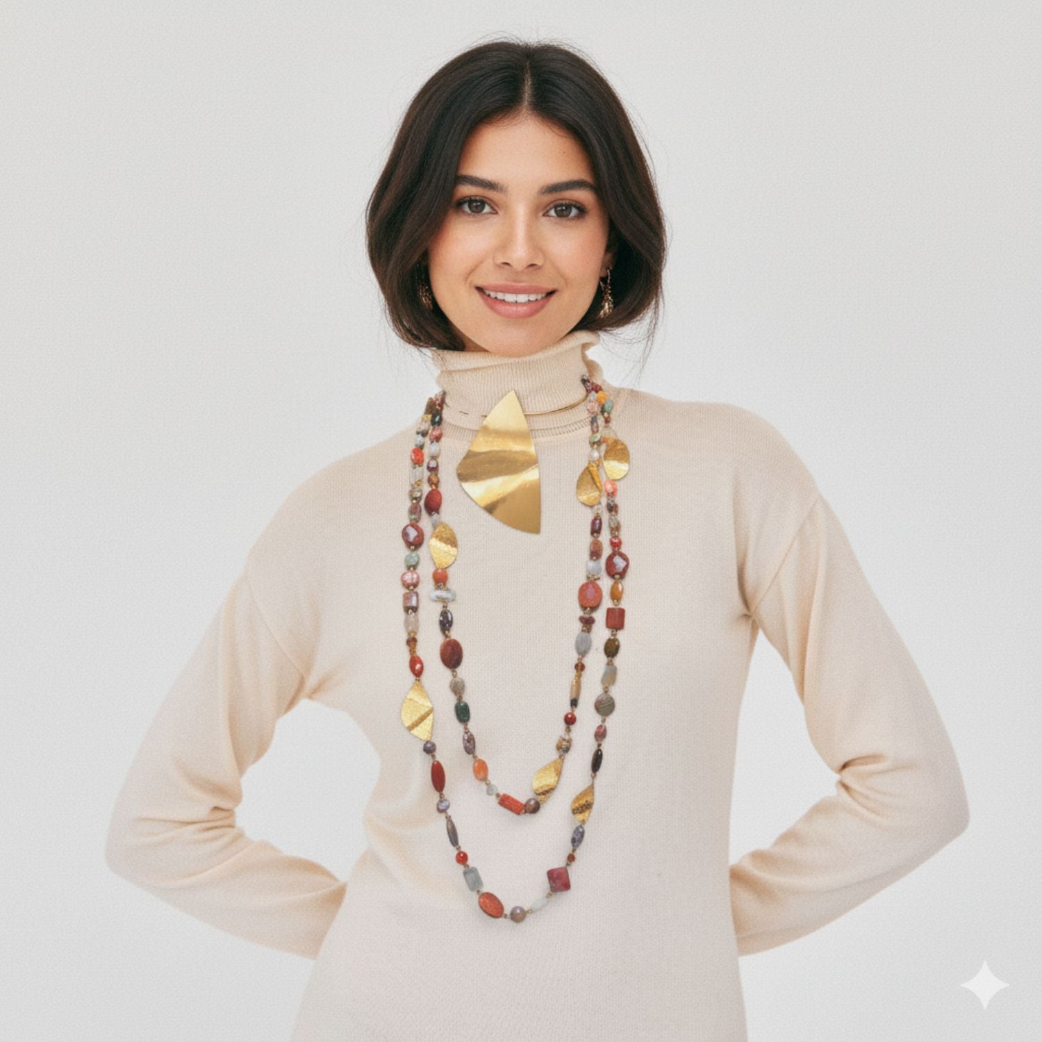 The Geo Twist Gemstone Linked Necklace by JAREDJAMIN Jewelry Online showcases earthy jasper stones in brown, amber, cream, and gray with textured 18K gold-plated charms for a layered artisanal look on a white background.