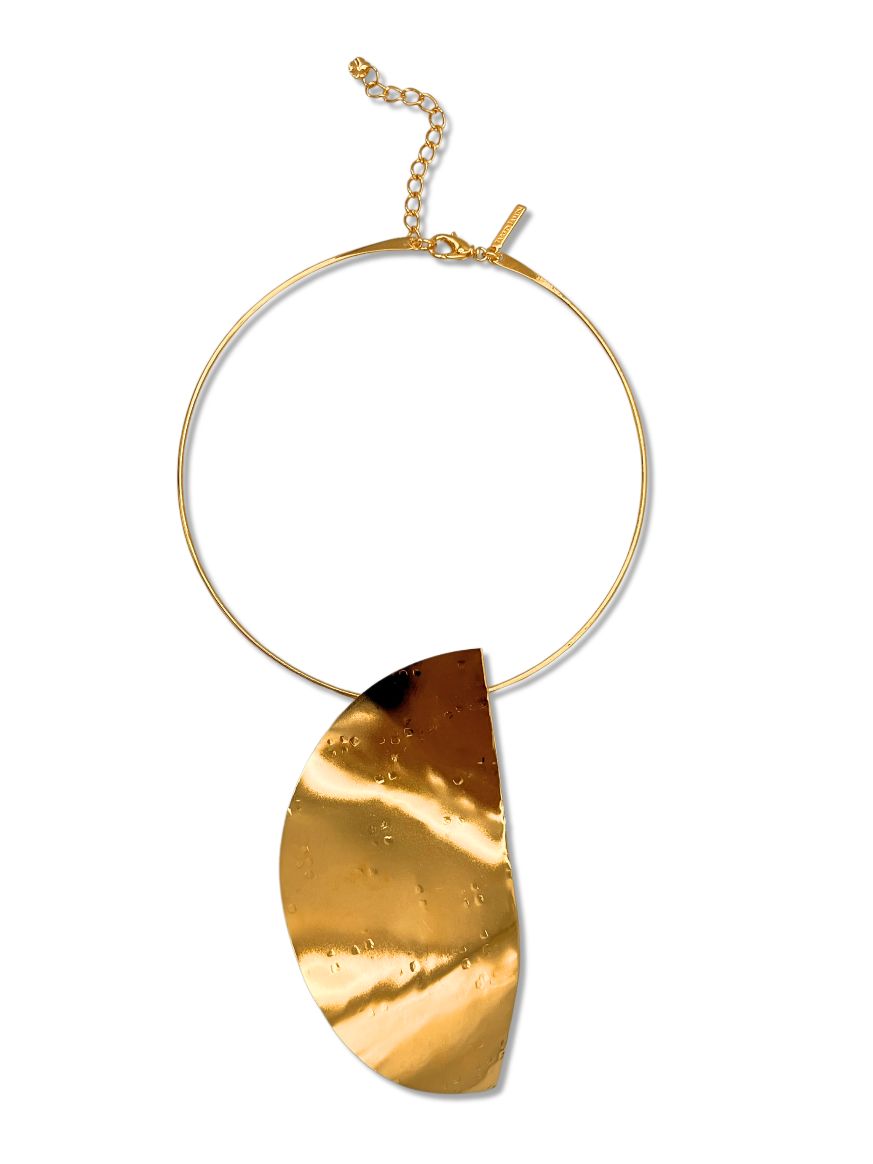 The Geo Twist Pendant Neck Wire from JAREDJAMIN Jewelry Online is an elegant gold choker with a wide band and adjustable clasp. It features an 18K hammered gold crescent pendant that adds subtle dimples and reflections.