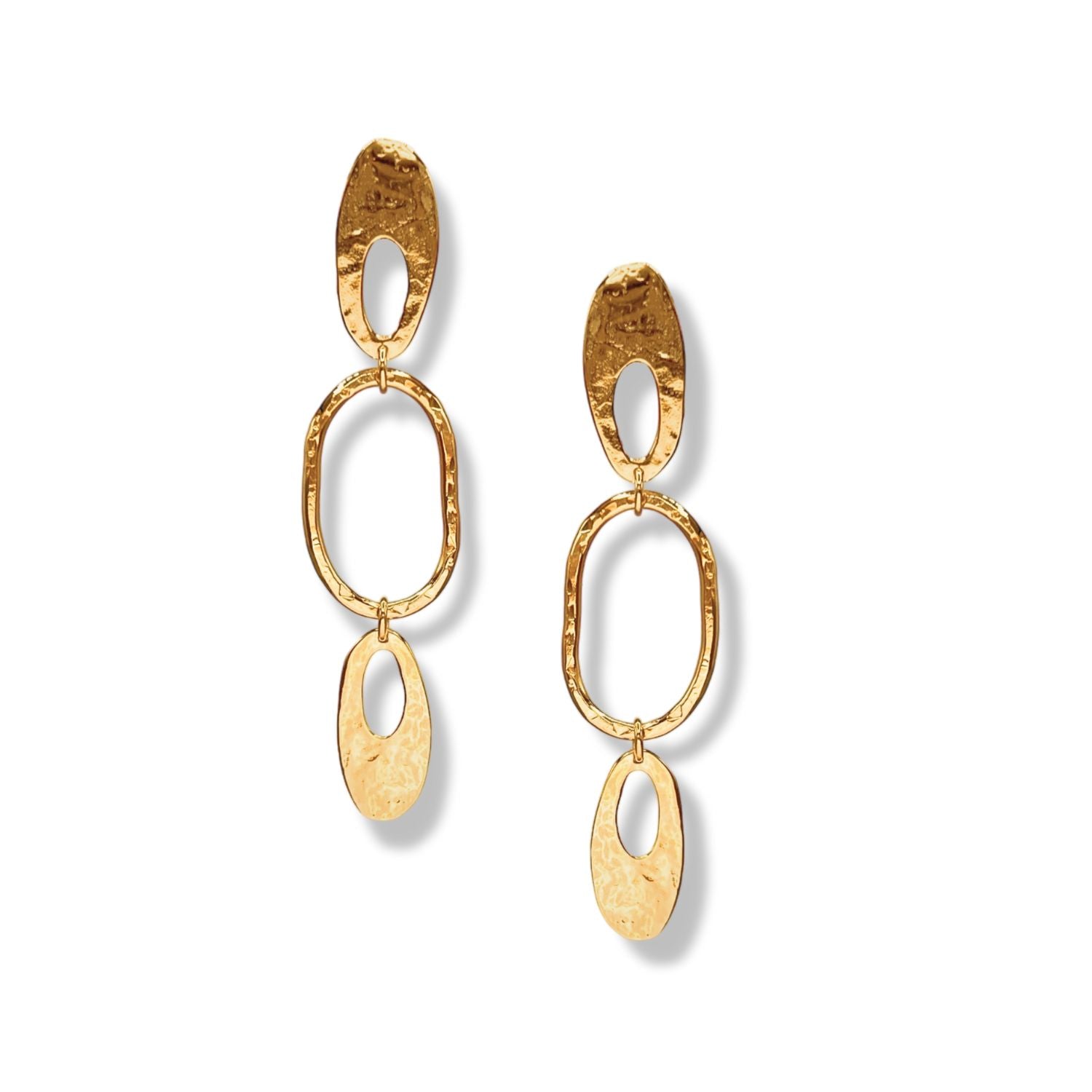 The Atomic Age Drop Earrings by JAREDJAMIN Jewelry Online feature three hammered oval and teardrop links in 18K gold-plated metal, radiating celestial energy with a vertical oval, bold center oval, and teardrop accent in each earring.