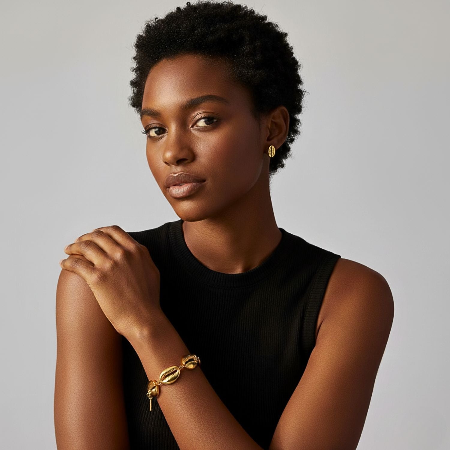 The Gold Bel Mare Cowrie Seashell Bracelet by JAREDJAMIN Jewelry Online features five detailed 18K gold-plated cowrie shell charms, evenly spaced on a toggle chain with a signature engraved tag for an elegant, ocean-inspired look.