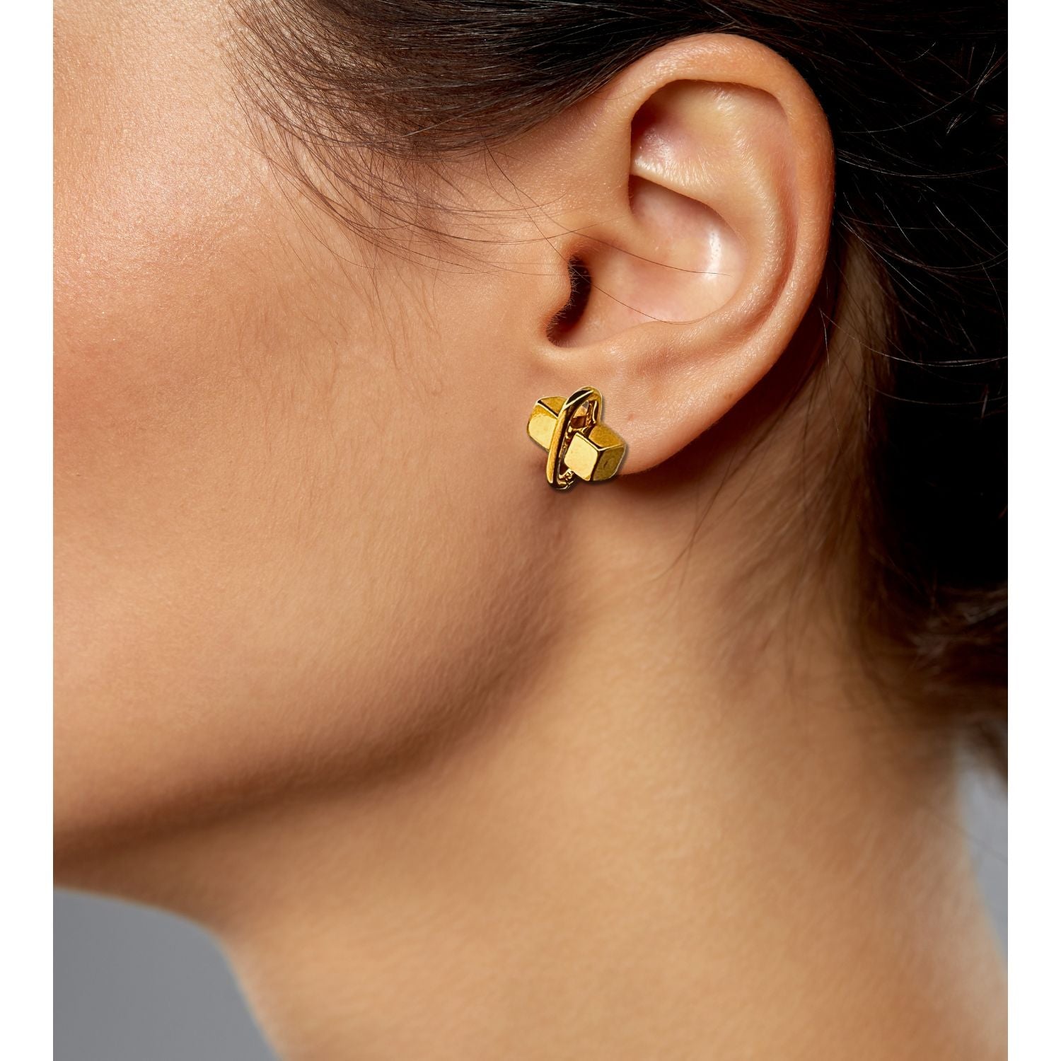 Gold Blockbuster Stud Post Earrings by JAREDJAMIN Jewelry Online feature geometric cube shapes intersected by circular loops. These 18K gold plated earrings have a polished, sculptural finish and are displayed on a white background with soft gray shadows.