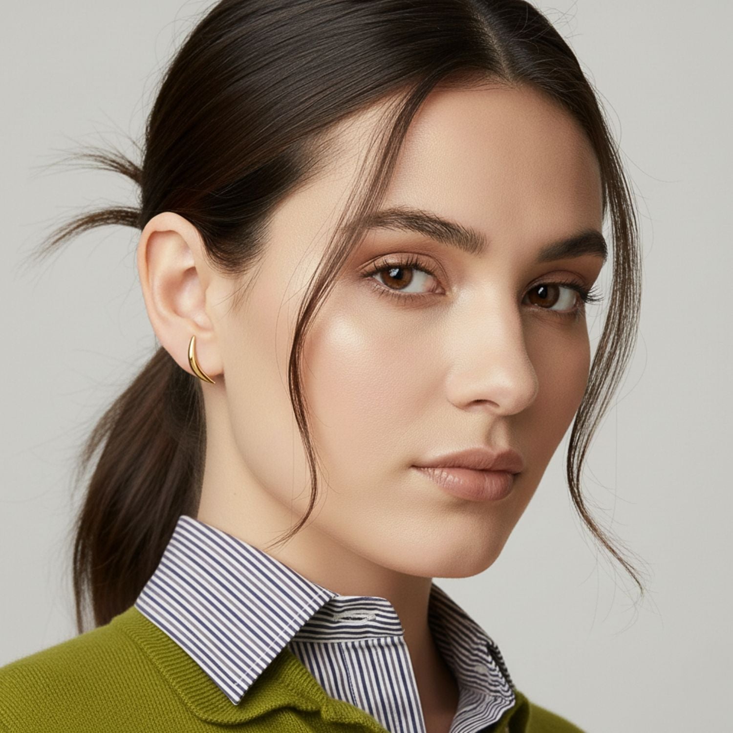 The Gold Crescent Stud Post Earrings by JAREDJAMIN Jewelry Online are shown on a white background, featuring a minimalist crescent shape in 18K gold plated finish with smooth edges and a glossy metallic shine.