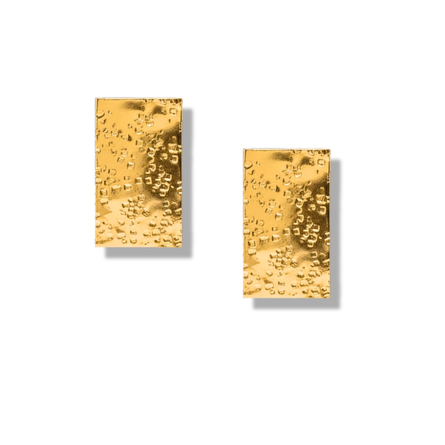 The Gold Cuszco Post Earrings by JAREDJAMIN feature a hammered texture and shiny 18k gold plating, with small, irregular indentations for a minimal and elegant look. Displayed on a plain white background with soft shadows.