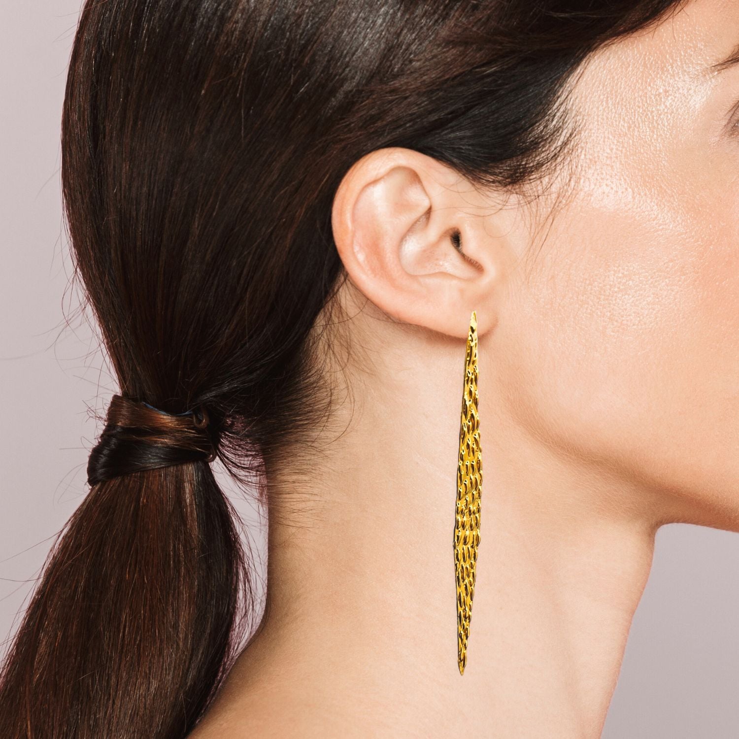 The Jaguaretê Earrings by JAREDJAMIN Jewelry Online, crafted in 18K gold with a textured lattice design, stand symmetrically against a plain white background, casting soft shadows.