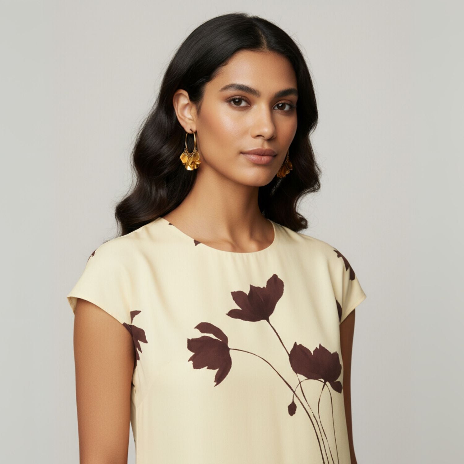 The Gold Large Petali Click-Top Hoop Earrings by JAREDJAMIN Jewelry Online feature 18K gold-plated petal-shaped charms and a seamless closure, shown on a white background with elegant shadows that highlight their decorative shine.