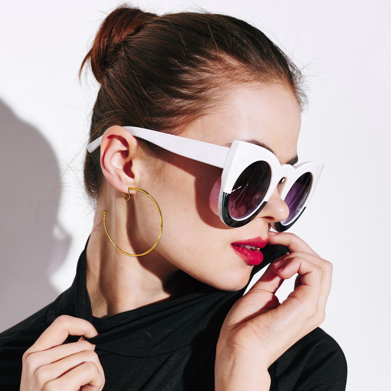 The Gold Medium Hooptastic Clip On Hoop Earrings by JAREDJAMIN Jewelry Online feature a hammered 18K gold finish, rounded ends, and hinged clasps. Arranged diagonally, they stand out against a plain white background.