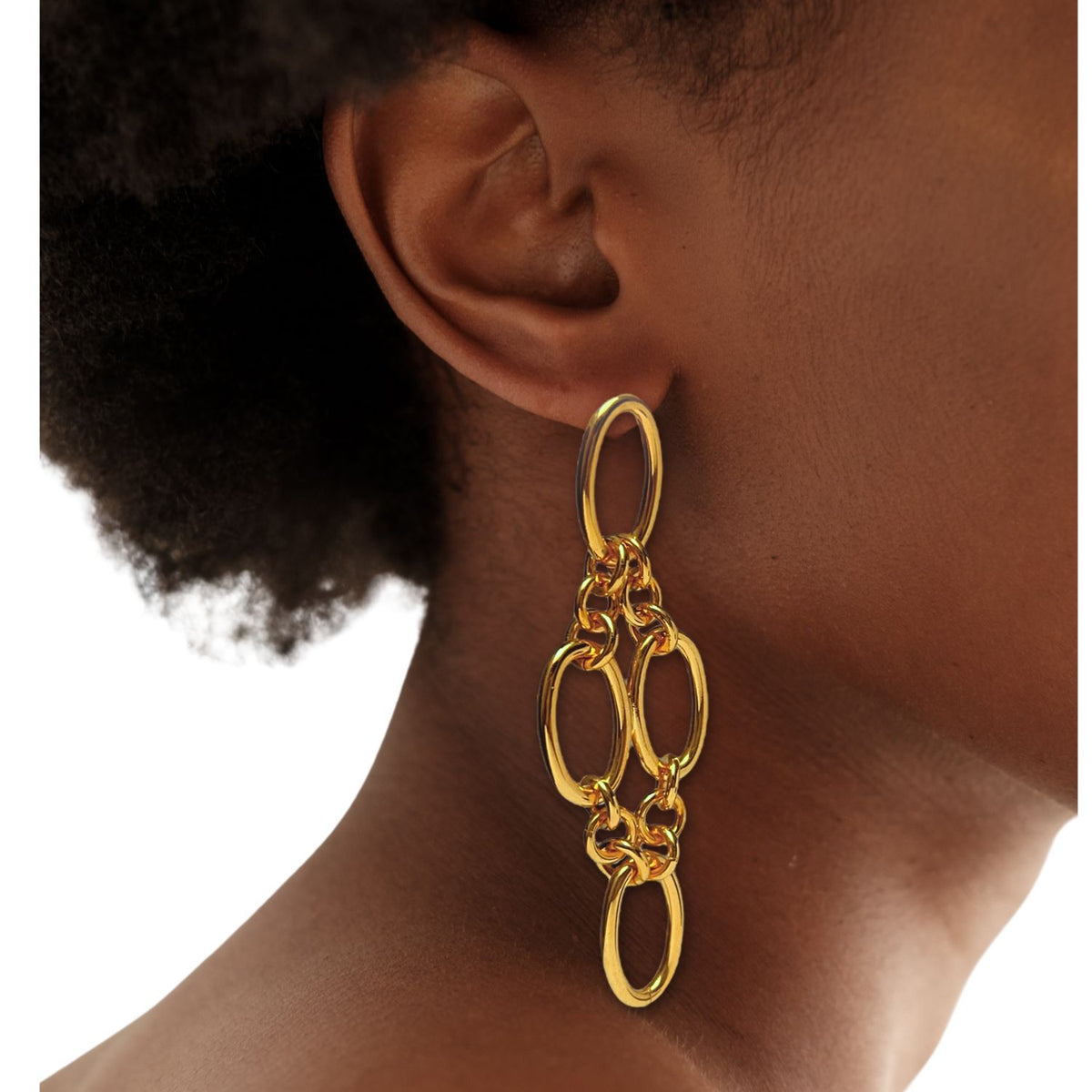 Close-up of a person&#39;s ear wearing Gold Ophelia Drop Post Earrings by JAREDJAMIN Jewelry Online—featuring large interlocking oval links with a shiny 18K gold-plated finish. Their short, curly hair and medium-brown skin pop against a plain light background.