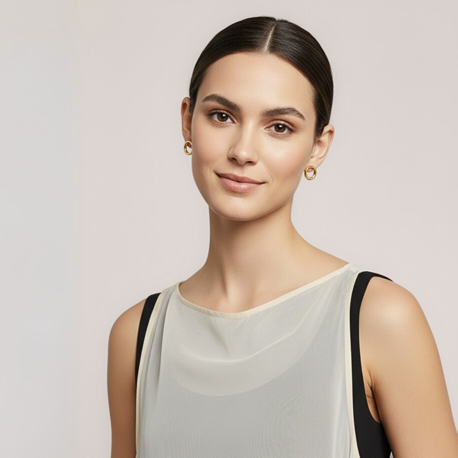 The Gold Small Rhodri Circular Post Earrings by JAREDJAMIN Jewelry Online feature double-looped, smooth, shiny 18K gold-plated hollow circles. Shown on a white background with faint shadows to the right.