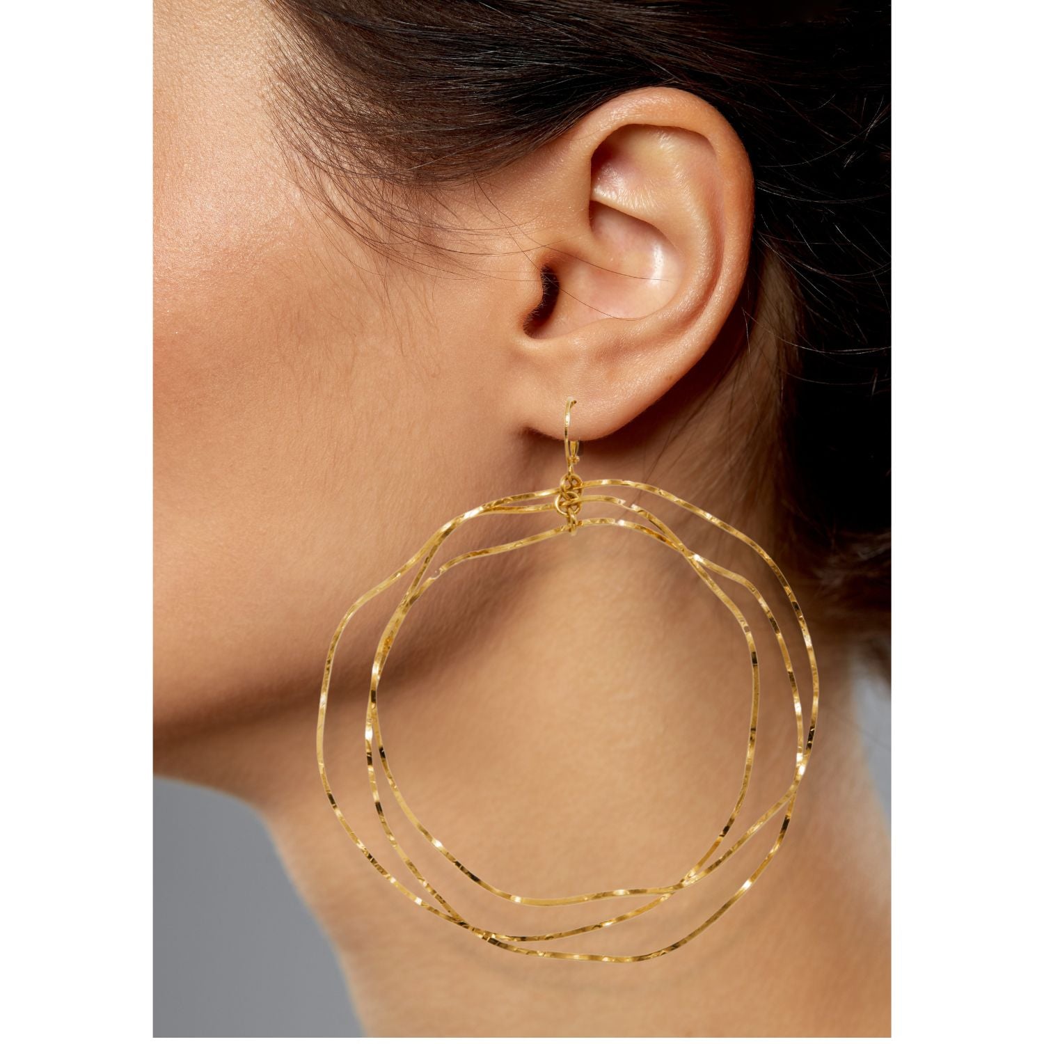 The Gold Triple Wavy Halo Hoop Earrings by JAREDJAMIN Jewelry Online feature three interlocking, irregular gold-plated brass wires with a lightly hammered texture for subtle shine and an organic, layered look.