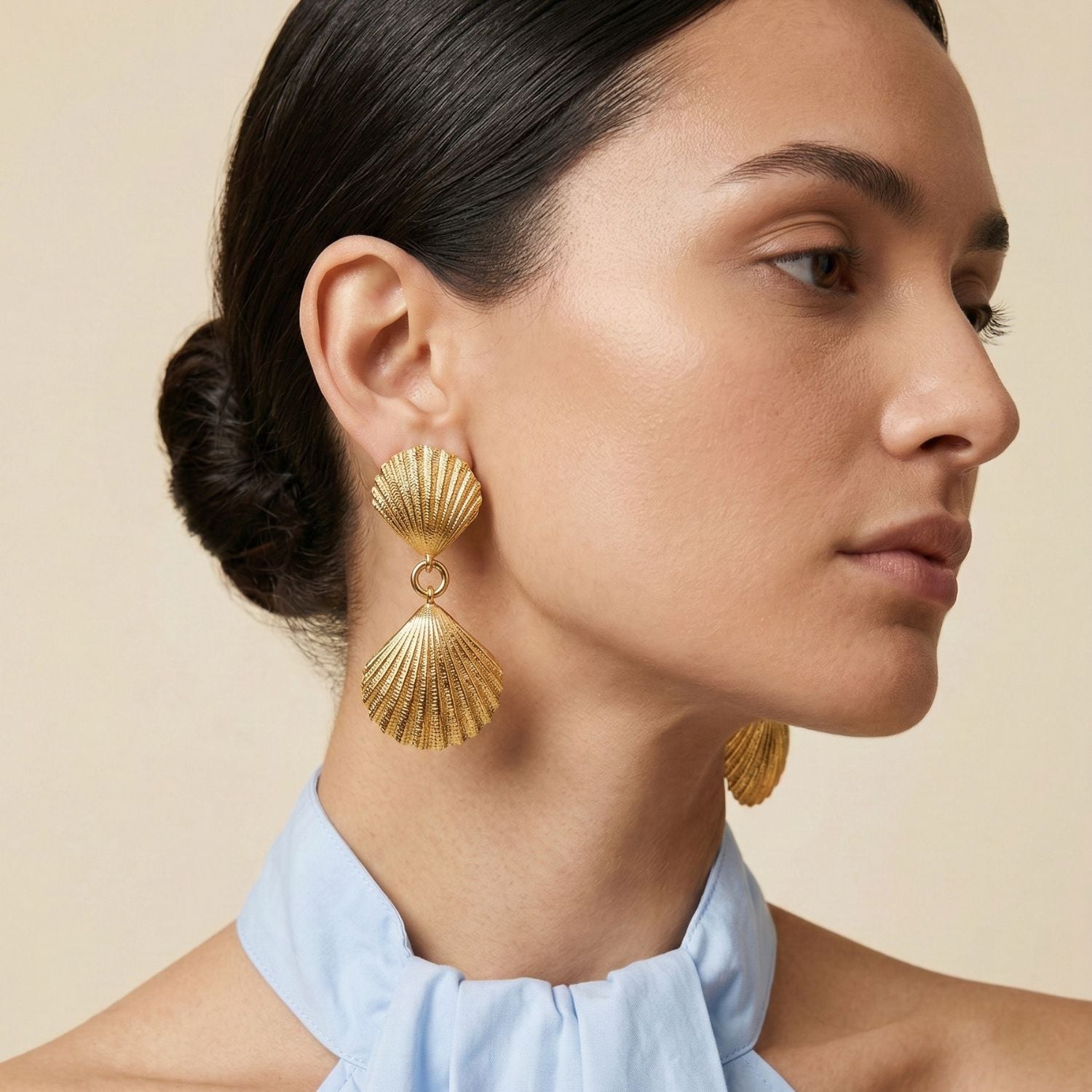 The Gold Venus Clip On Earrings by JAREDJAMIN Jewelry Online feature two textured, gold scallop shells connected by a small ring for a dangle effect—perfect resort-ready shell-inspired jewelry.