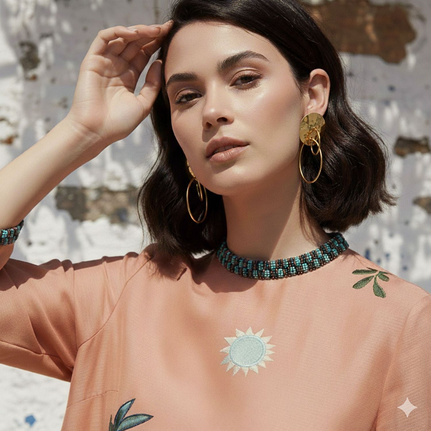 The Gold Viviane Clip-on Earrings by JAREDJAMIN Jewelry Online feature textured, hammered round studs with dangling gold hoops in a shiny finish, casting soft shadows on a white background.