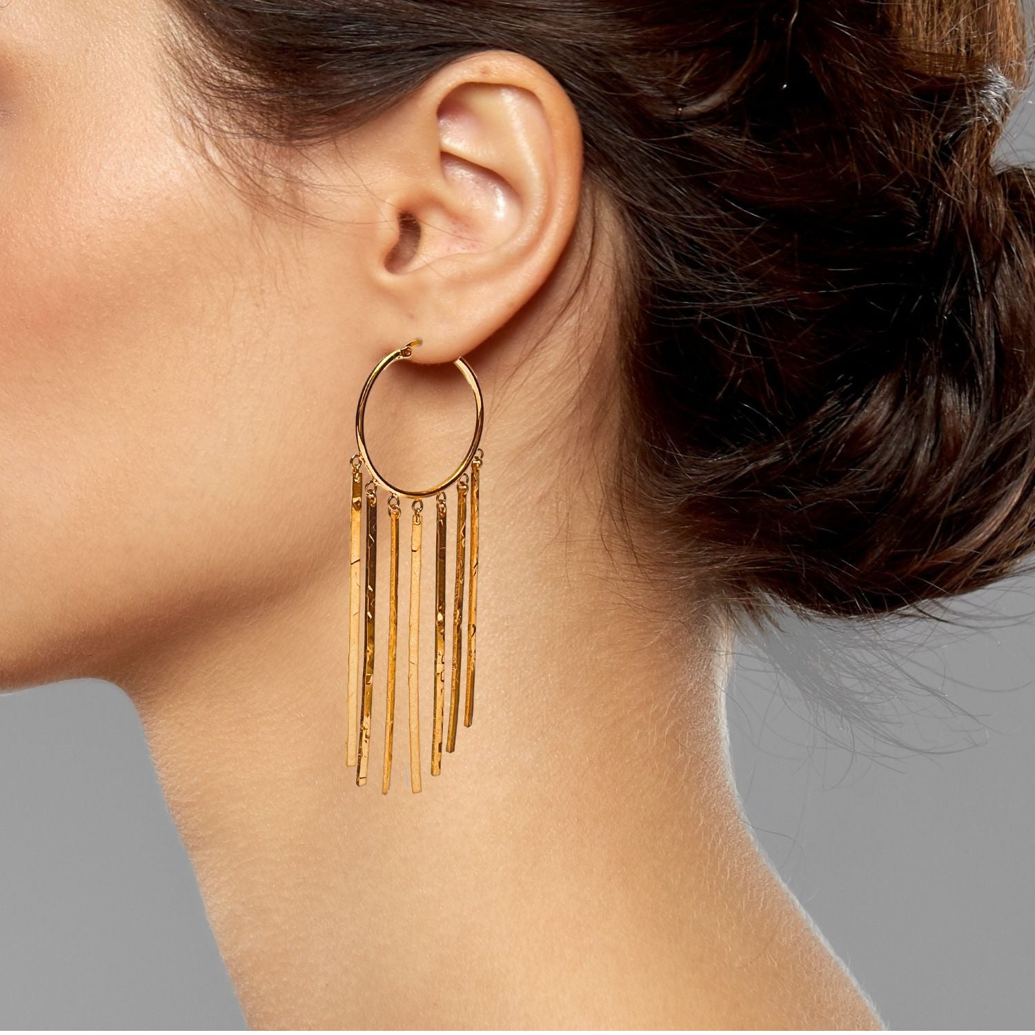 The JAREDJAMIN Jewelry Online Gold Wind Catcher Leverback Dangle Earrings feature multiple thin, textured 18K gold plated bars in a fringe pattern, creating an elegant, Mesoamerican-inspired statement look. White background.