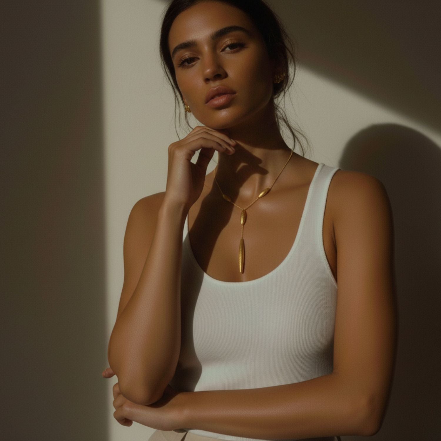 The Gold Zeppelin Y-Necklace by JAREDJAMIN Jewelry Online features a delicate, E-coated 18K gold-plated chain with three oval beads and a long tapered center bead, plus an adjustable clasp for the perfect fit.