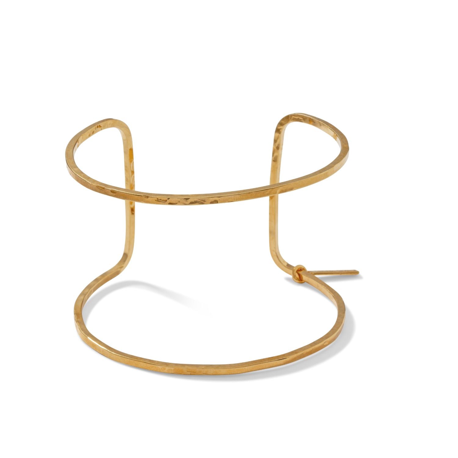 The Gold Halo Forge Textured Cuff by JAREDJAMIN Jewelry Online is a minimalist, open-ended 18K gold-plated brass cuff with a hammered finish, two overlapping curved bands, and a small rectangular tag at one end.