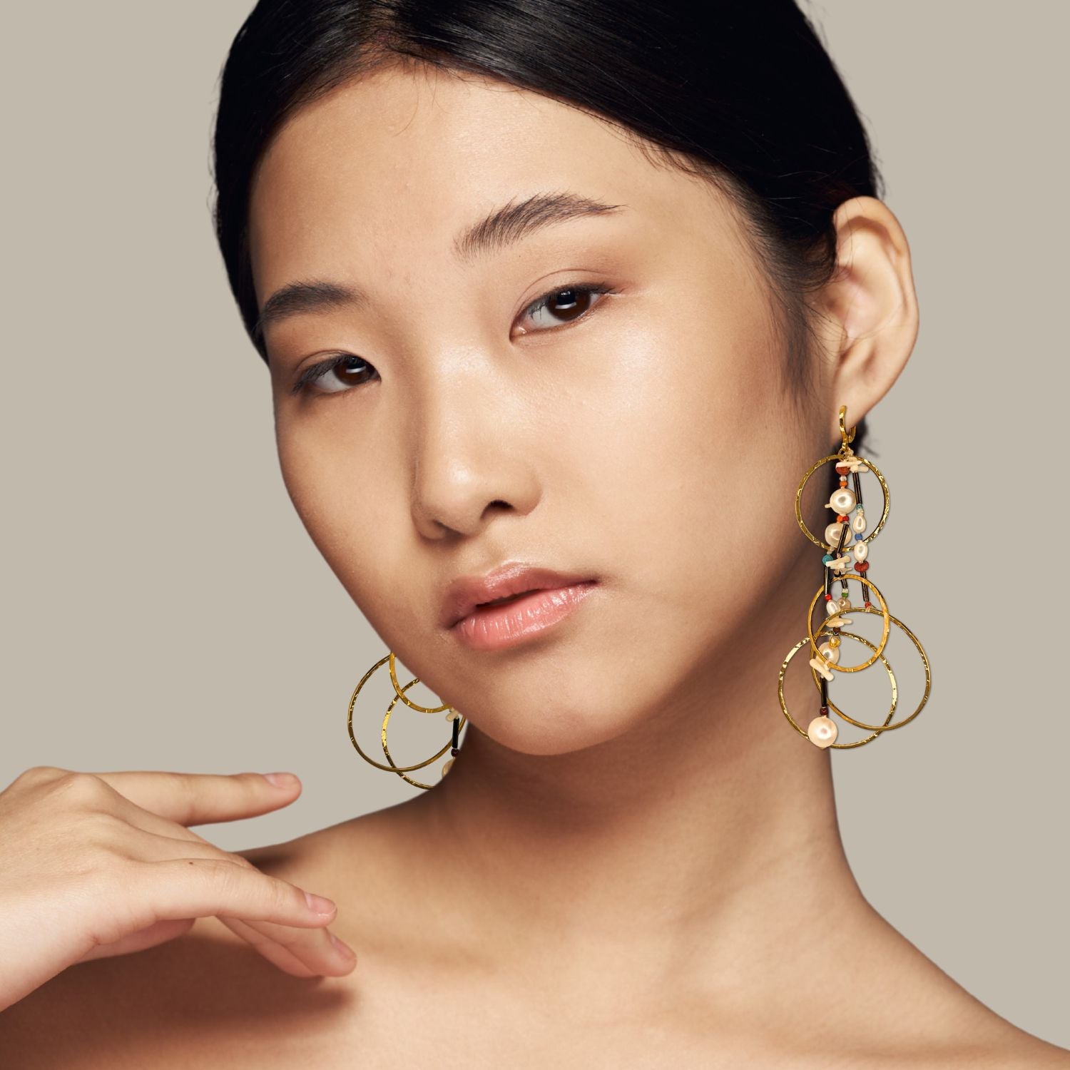 The Lindy Dream Catcher Dangle Earrings by JAREDJAMIN Jewelry Online feature three interlocking 18K gold circles with white pearls and blue, red, and green beads for a playful yet elegant bohemian style.