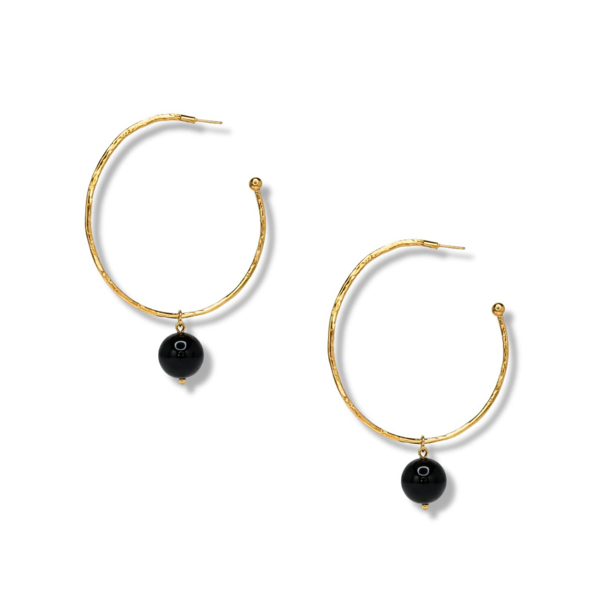 The Hooptastic Gemstone Drop Gold Hoop Earrings by JAREDJAMIN Jewelry Online feature large, thin 18K gold hoops with a textured finish and a central dangling black bead, elegantly displayed on a plain white background.