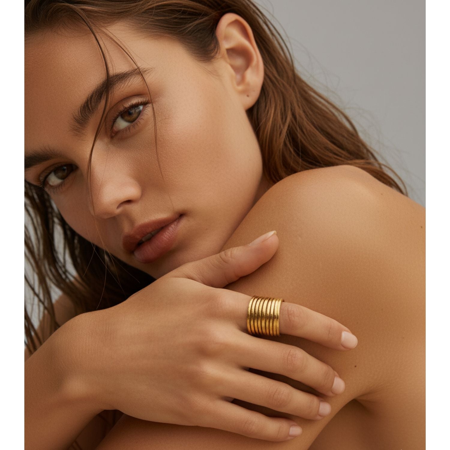 The Mirage 10 Stacked Ring by JAREDJAMIN Jewelry Online features multiple horizontal 18K gold bands for a layered, cage-like effect. This versatile piece is displayed on a plain white background.