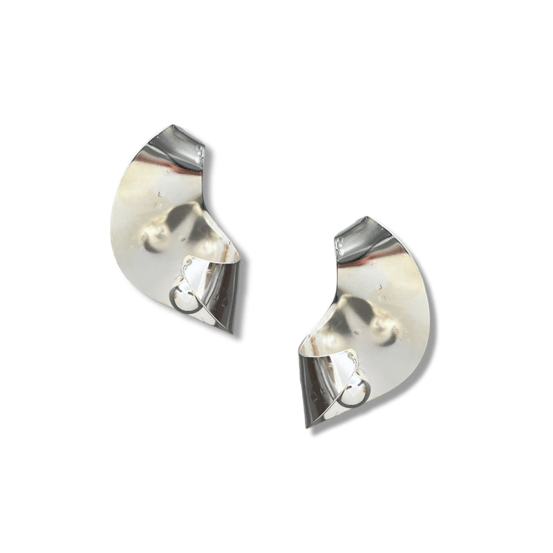 The Onda Ball Earrings by JAREDJAMIN Jewelry Online are shiny, curved silver pieces with abstract, asymmetrical folds and circular loops. Their smooth, reflective surfaces emphasize a sleek, modern design against a white background.