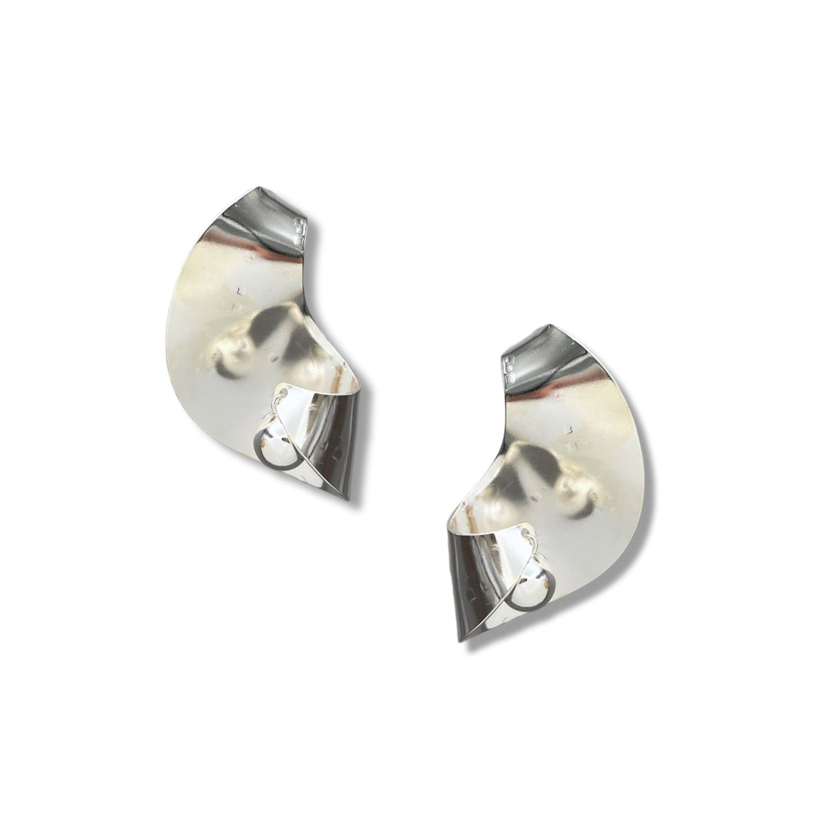 The Onda Ball Earrings by JAREDJAMIN Jewelry Online are shiny, curved silver pieces with abstract, asymmetrical folds and circular loops. Their smooth, reflective surfaces emphasize a sleek, modern design against a white background.