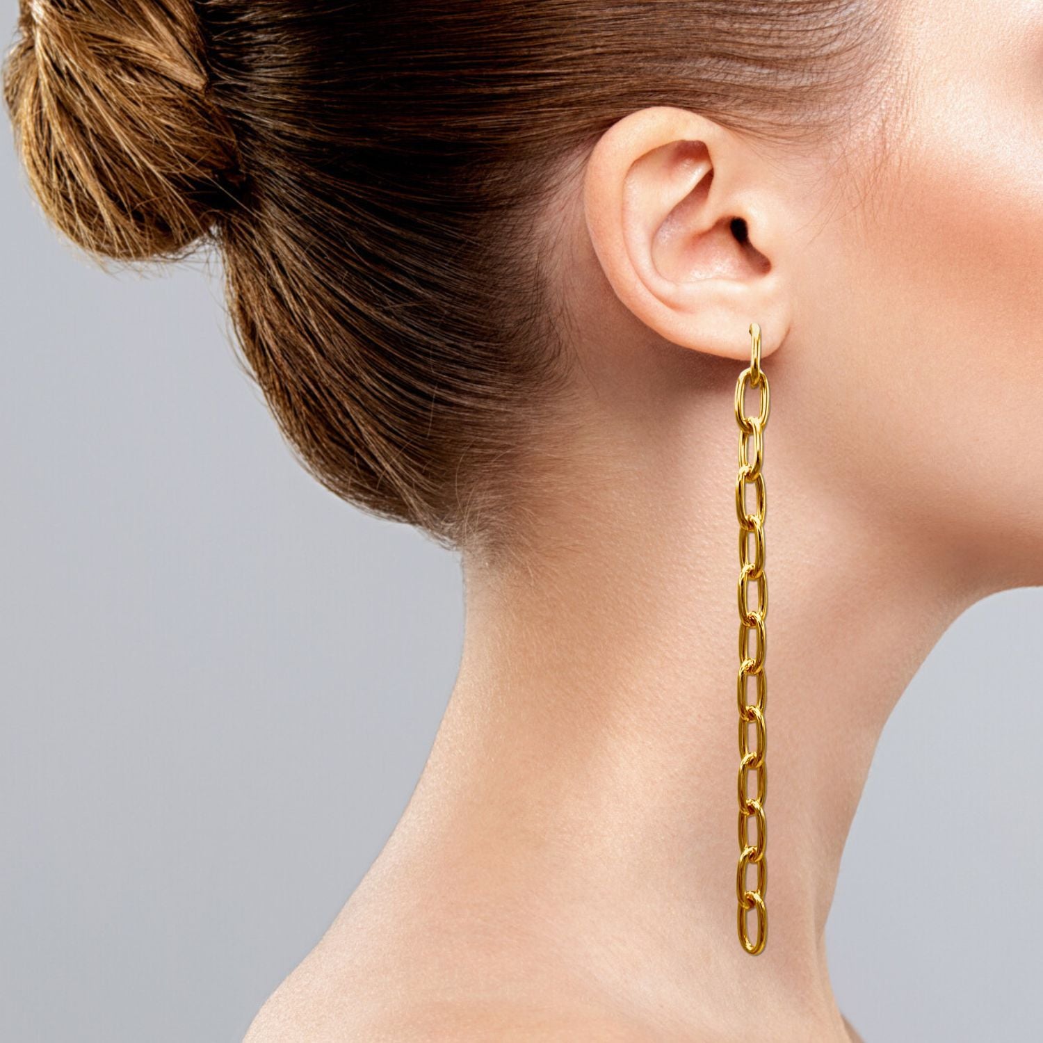 The Chain Reaction Dangle Post Earrings from JAREDJAMIN Jewelry Online showcase gold-plated interlocking oval links in a sleek vertical chain design with a polished finish, set against a plain white background.