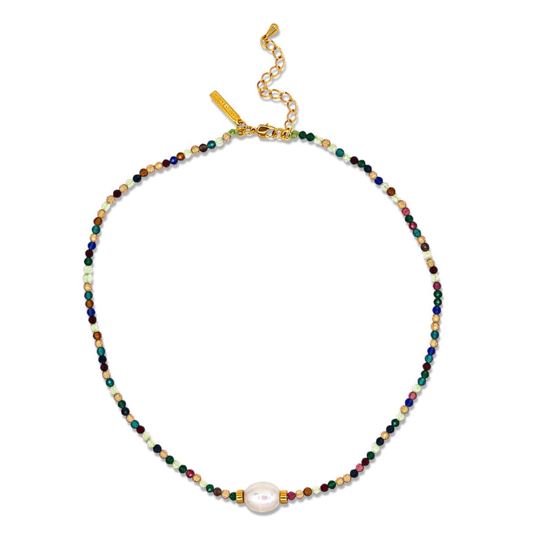The Rowan Multi Color Necklace by JAREDJAMIN Jewelry Online features multi-colored faceted beads in a vibrant pattern, a central large white freshwater pearl, and a gold clasp with extender and rectangular gold tag. Adjustable length.