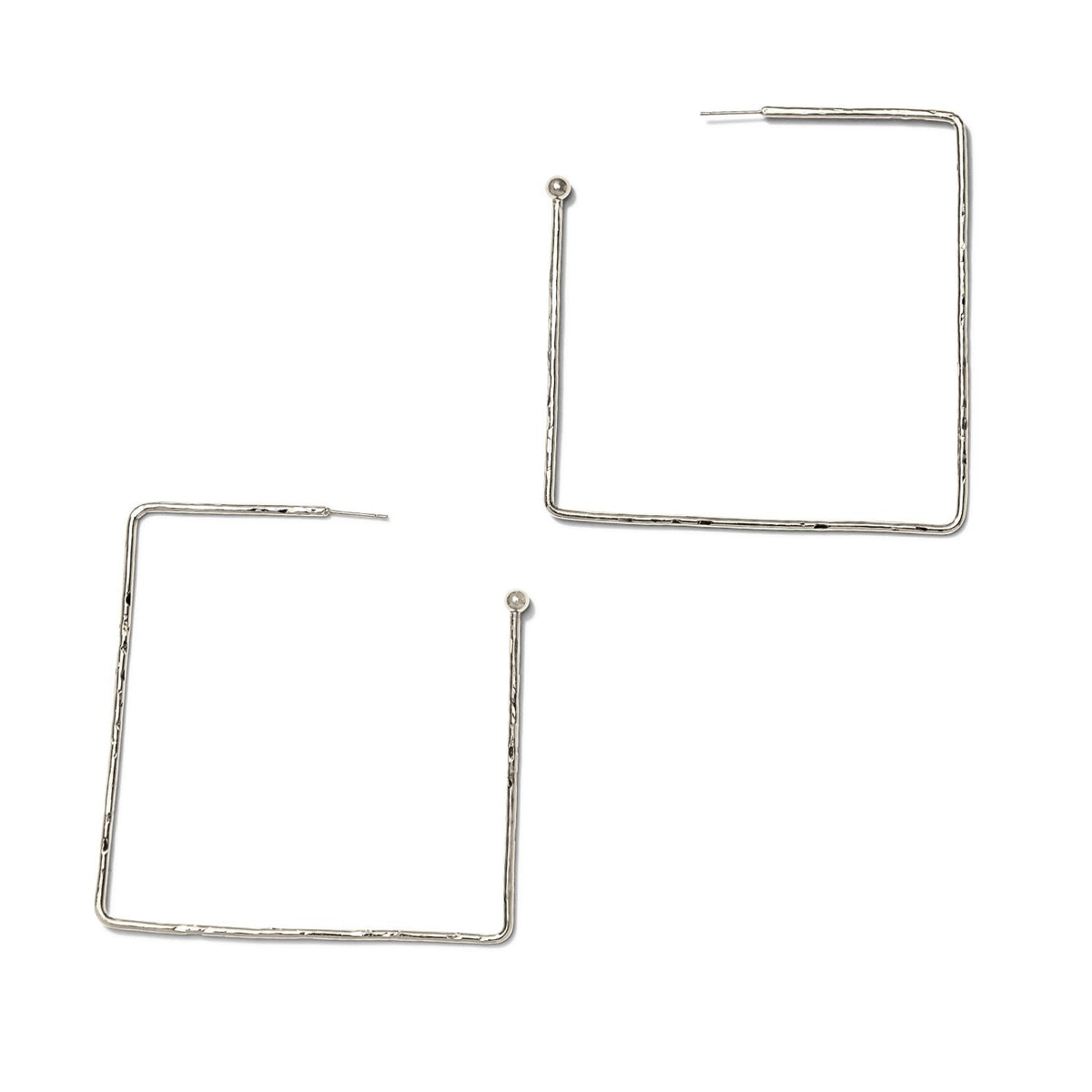 The Silver Squaretastic Hoop Post Earrings by JAREDJAMIN Jewelry Online are minimalist, silver-colored, square-shaped hoops with a thin, angular frame and hammered texture, displayed diagonally on a plain white background.